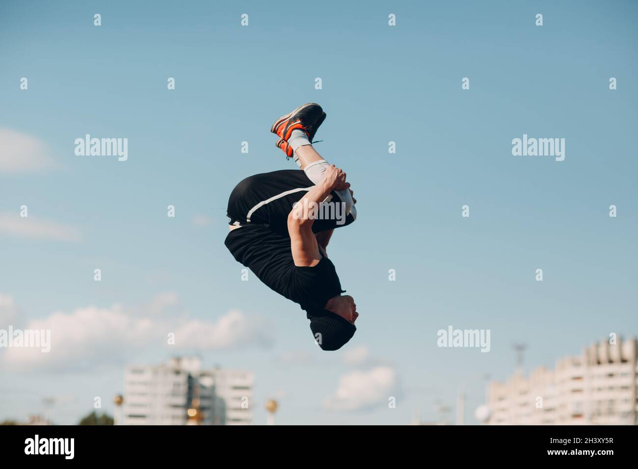 Young sporty guy doing parkour at the city street. Stock Photo