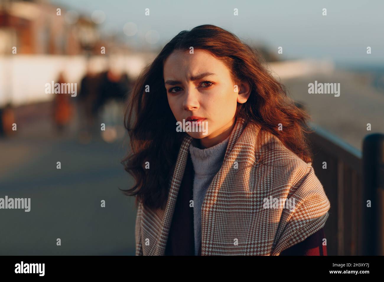 Young woman in coat at coast outdoors. Stock Photo