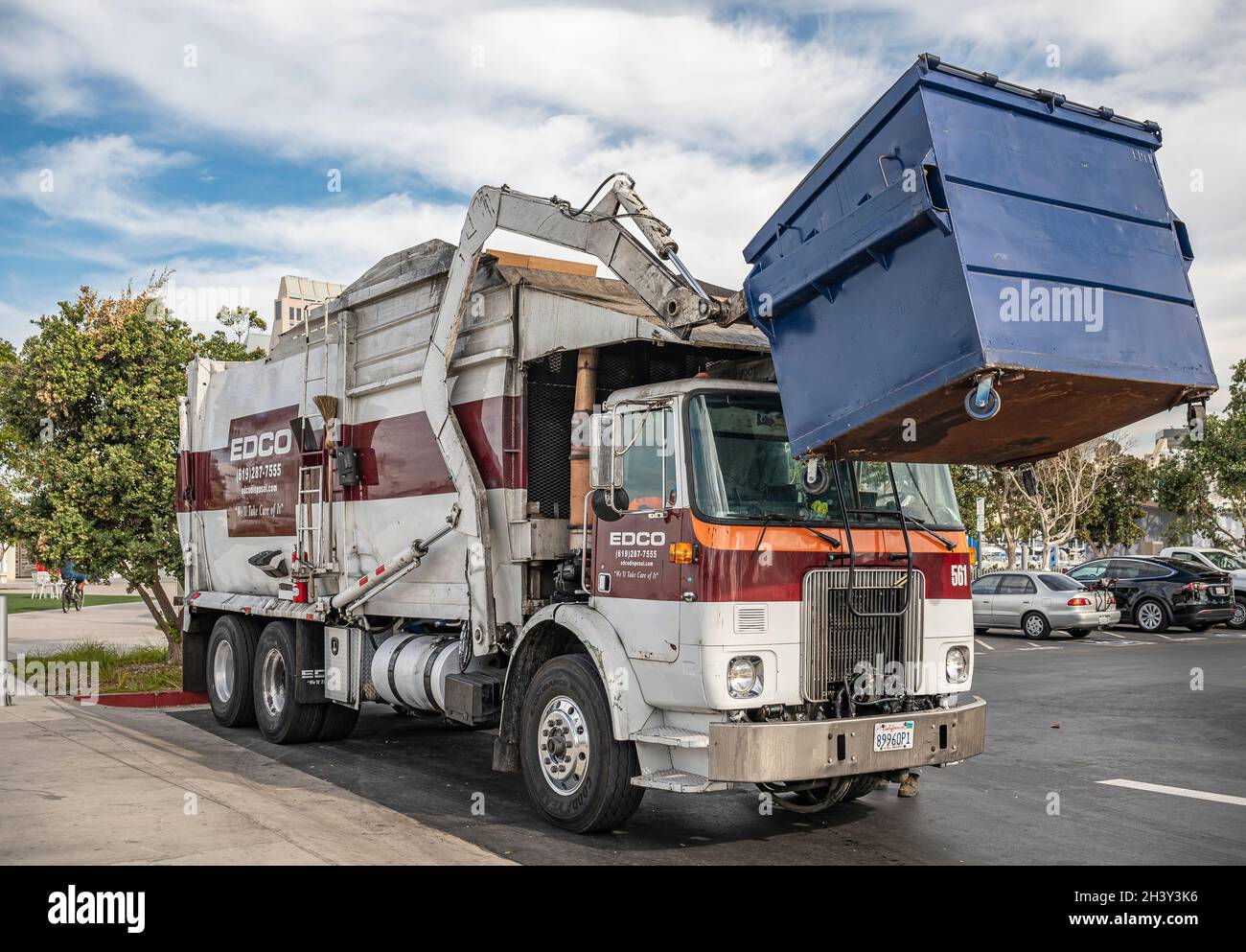 San Diego, California, USA - October 4, 2021: South Embarcadero boardwalk.  White-brown front-loading EDCO trash pickup truck in operation under blue c  Stock Photo - Alamy