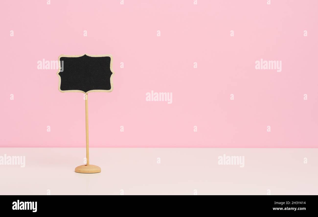 Empty wooden pointer on a stick for writing text, pink background Stock ...