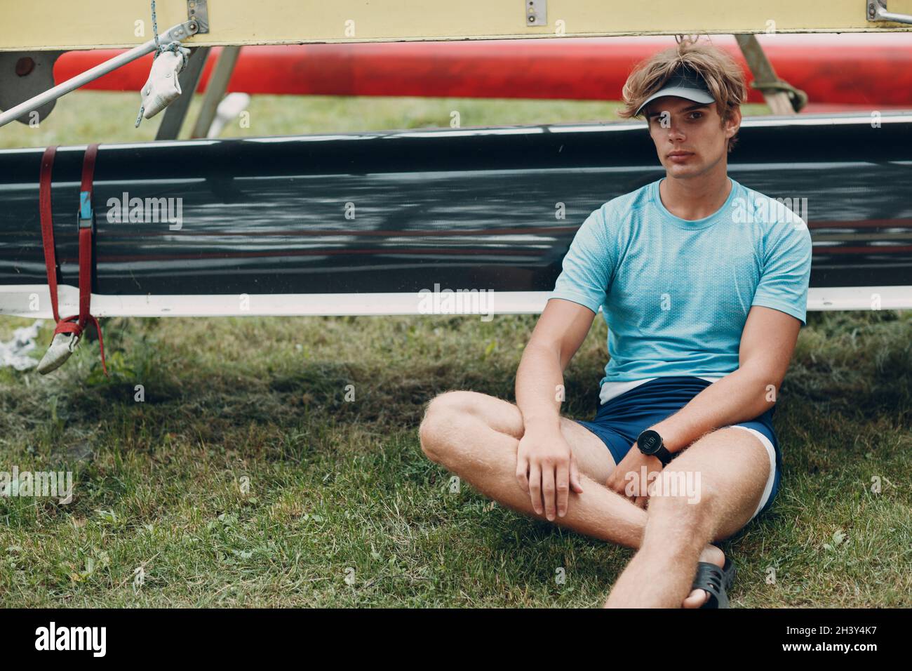 Sportsman single scull man rower prepare to competition with boat. Olympic games sport. Stock Photo