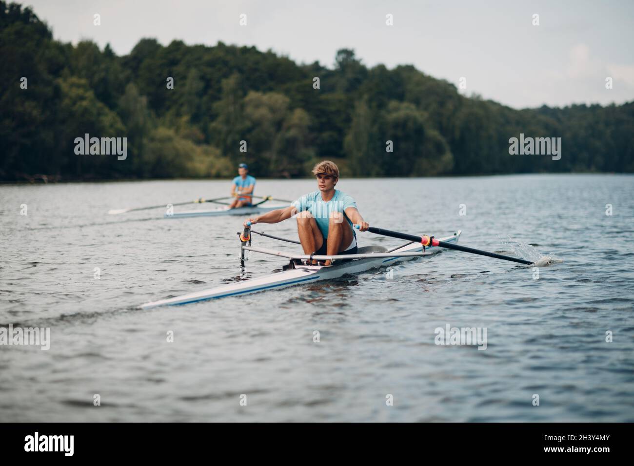 Sportsman single scull man rower rowing on boat Stock Photo