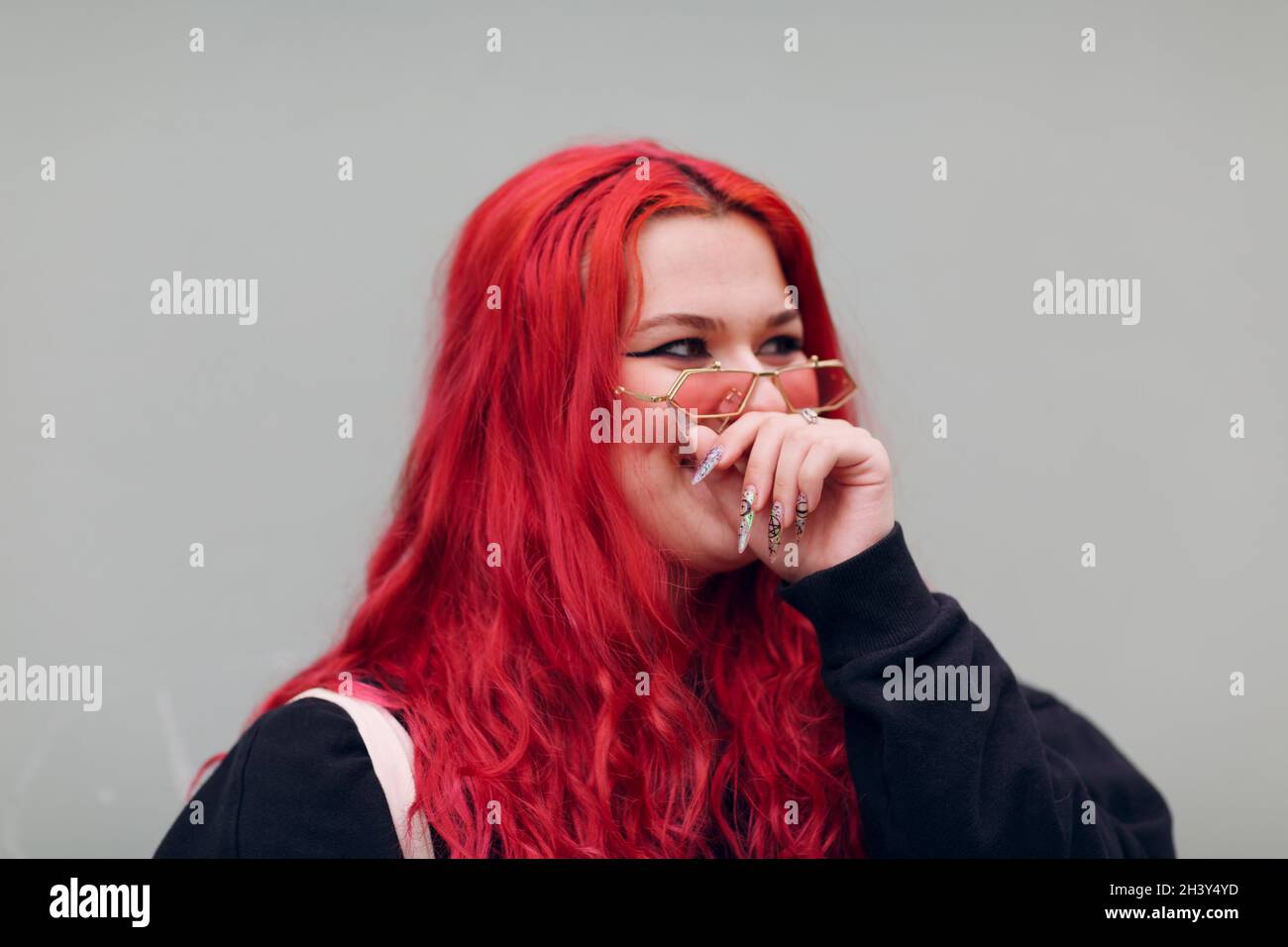 Plus size overweight fat body positive lgbtq woman with red hair and pink glasses Stock Photo
