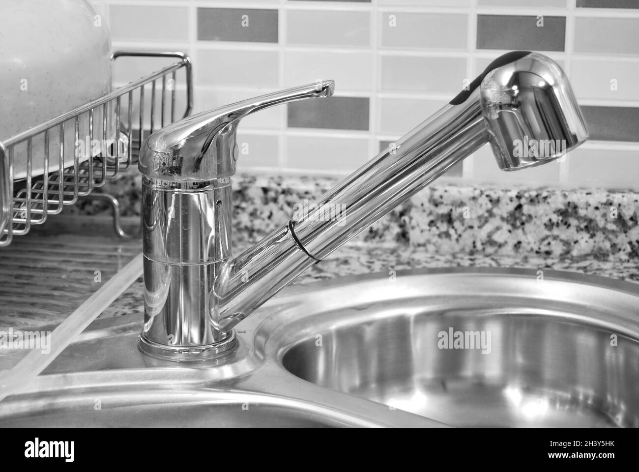 Interior of luxurious modern kitchen and stainless steel sink, tap and drain Stock Photo