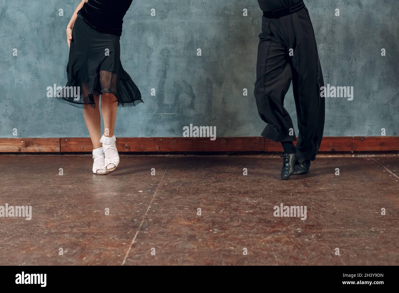 Legs of young couple boy and girl dancing in ballroom dance Jive Stock Photo