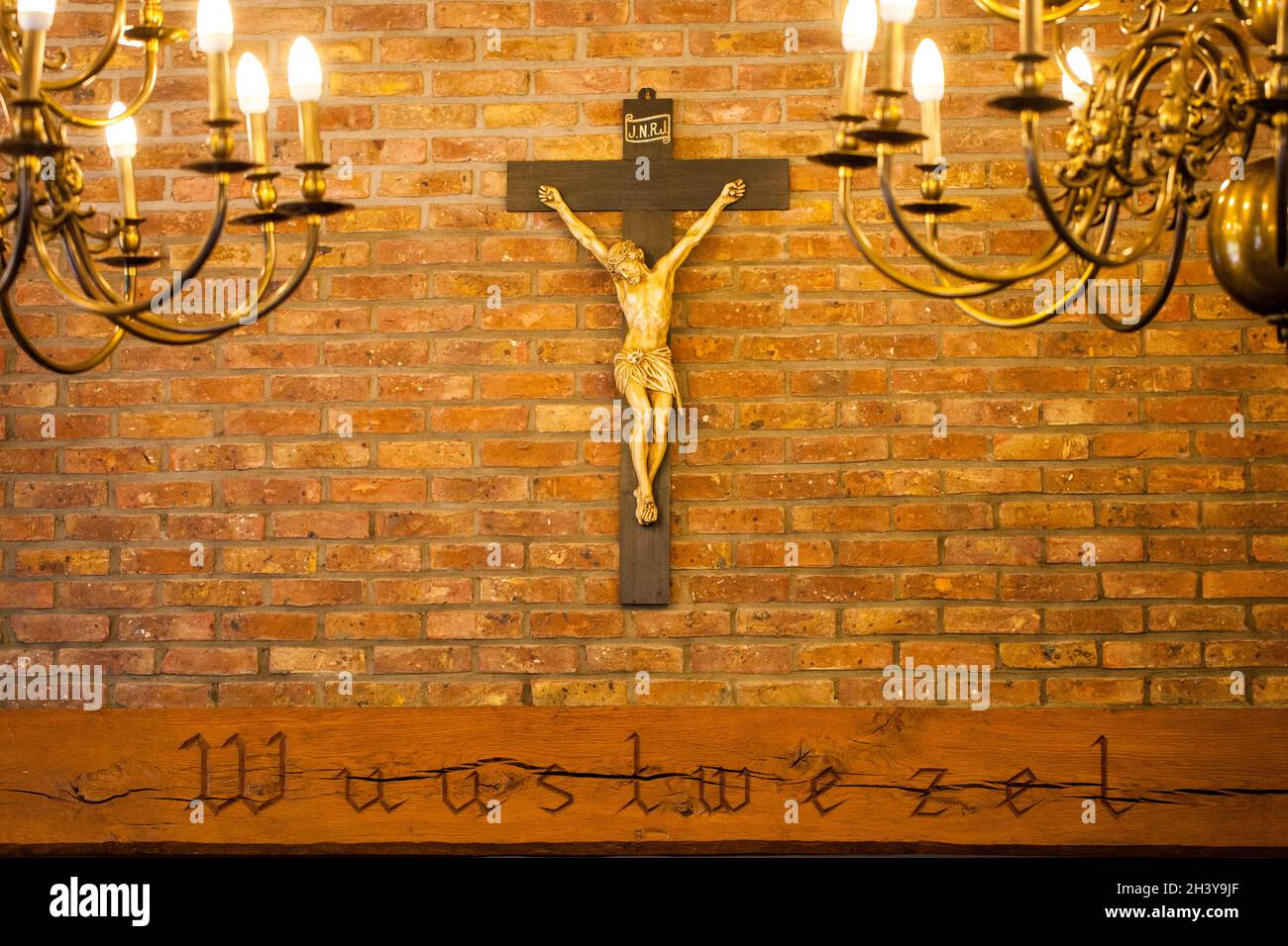 Crucifix on wall of old church. Catholic crucifix with text space Stock