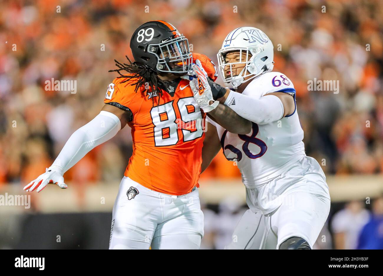 October 30, 2021: Oklahoma State defensive end Tyler Lacy (89) battles with Kansas offensive lineman Earl Bostick Jr. (68) during a football game between the Kansas Jayhawks and the Oklahoma State Cowboys at Boone Pickens Stadium in Stillwater, OK. Gray Siegel/CSM Stock Photo