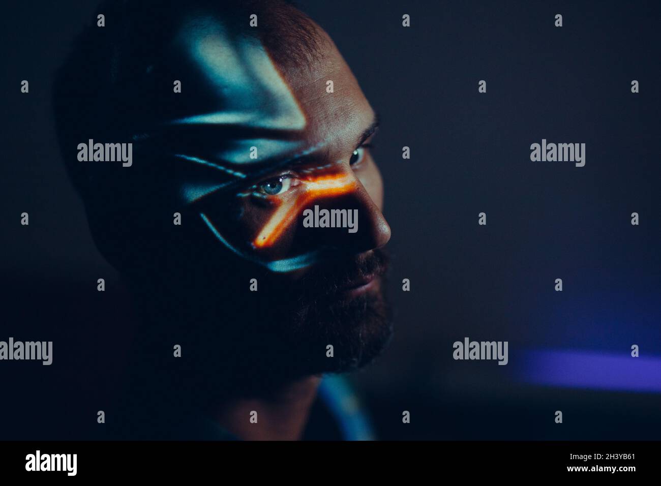 Artistic portrait of a man face in light paint projection. Stock Photo