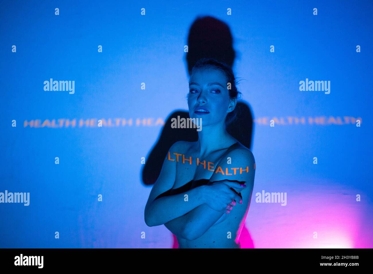 Young adult woman with word Health on her body. Stock Photo
