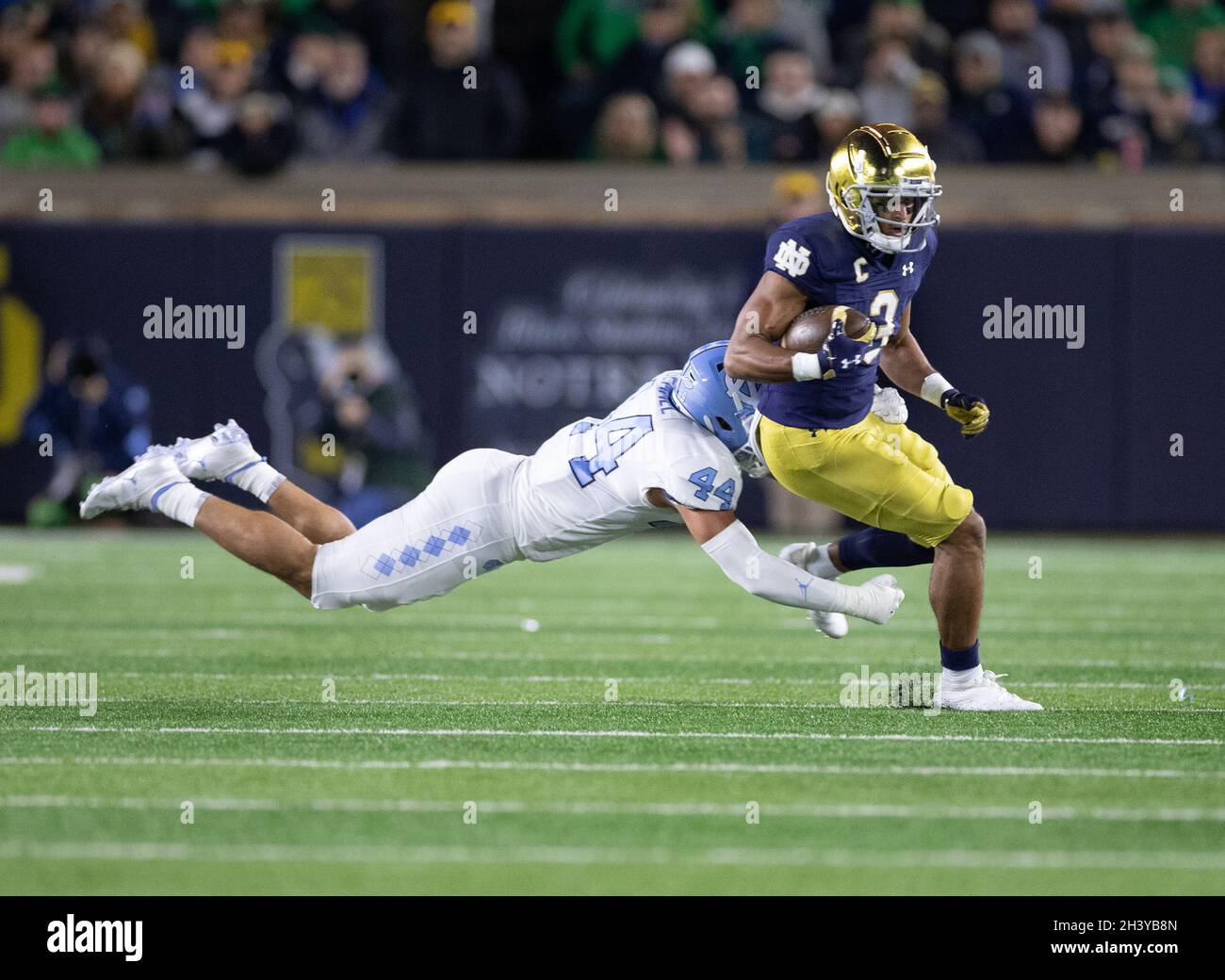 South Bend, Indiana, USA. 30th Oct, 2021. Notre Dame wide receiver Avery Davis (3) runs with the ball after the catch as North Carolina linebacker Jeremiah Gemmel (44) makes diving attempt at the tackle during NCAA football game action between the North Carolina Tar Heels and the Notre Dame Fighting Irish at Notre Dame Stadium in South Bend, Indiana. John Mersits/CSM/Alamy Live News Stock Photo