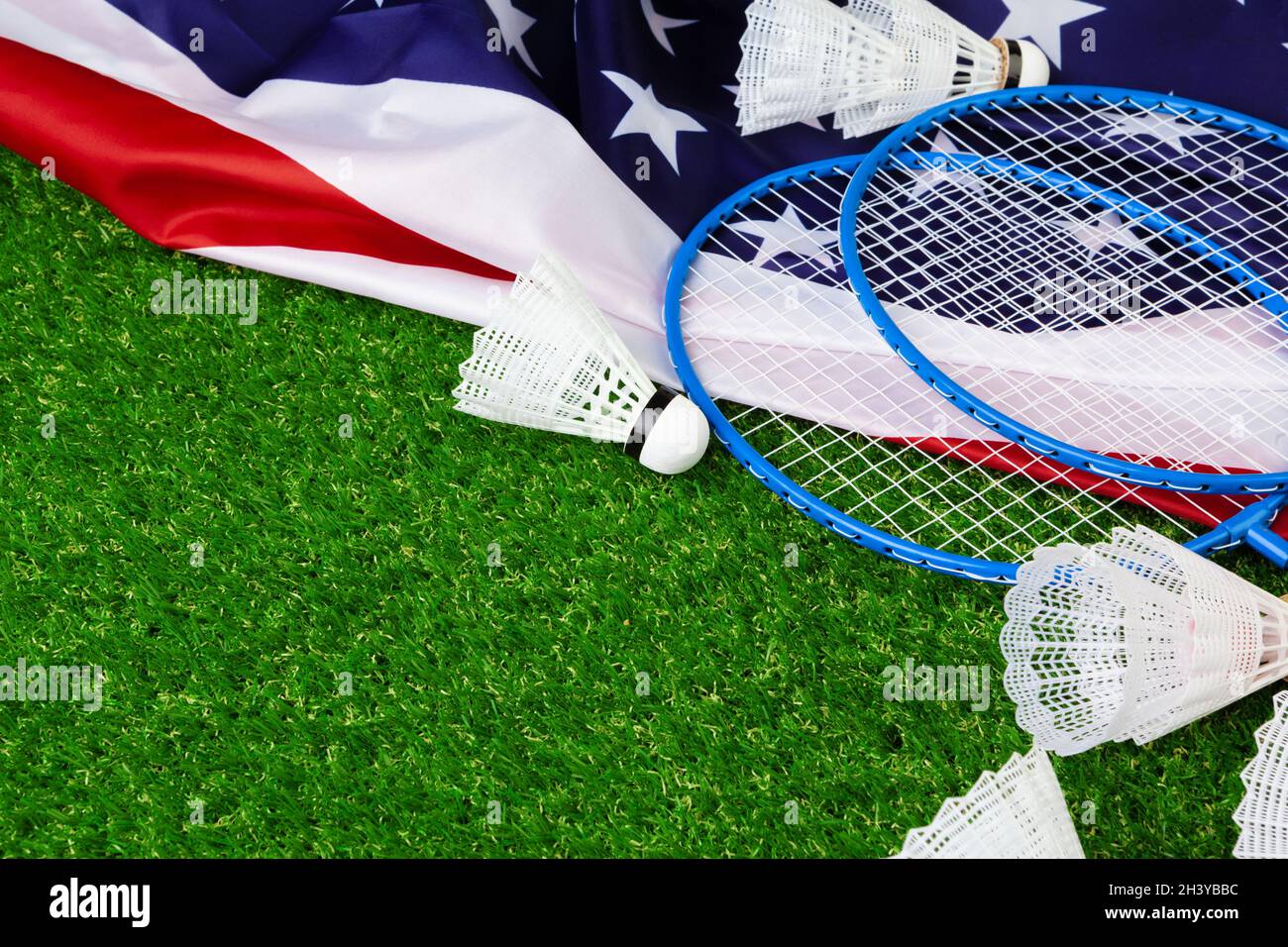 Badminton game rackets and shuttlecock on grass Stock Photo - Alamy