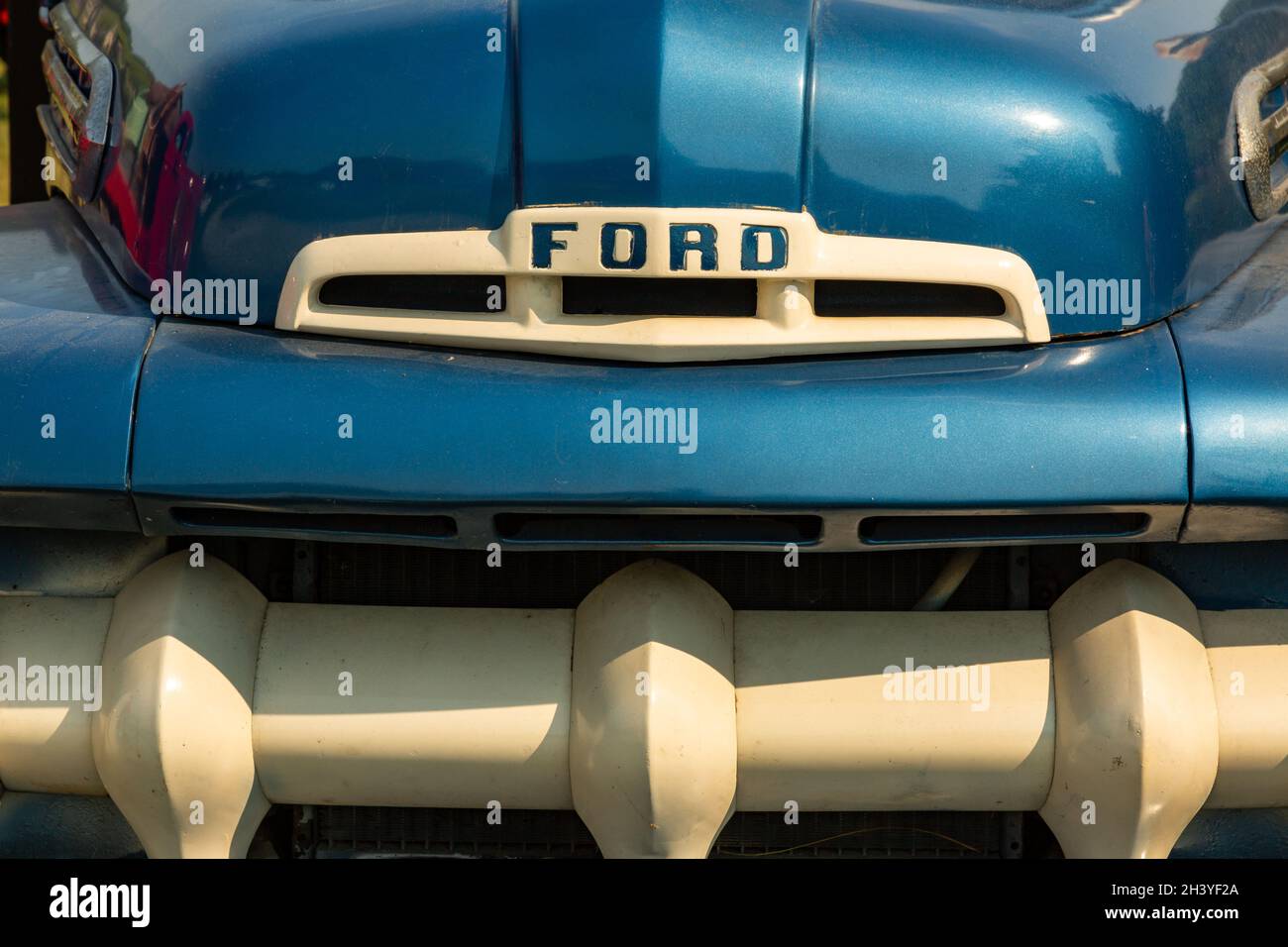 The iconic grill of an antique blue 1951 Ford truck. Stock Photo