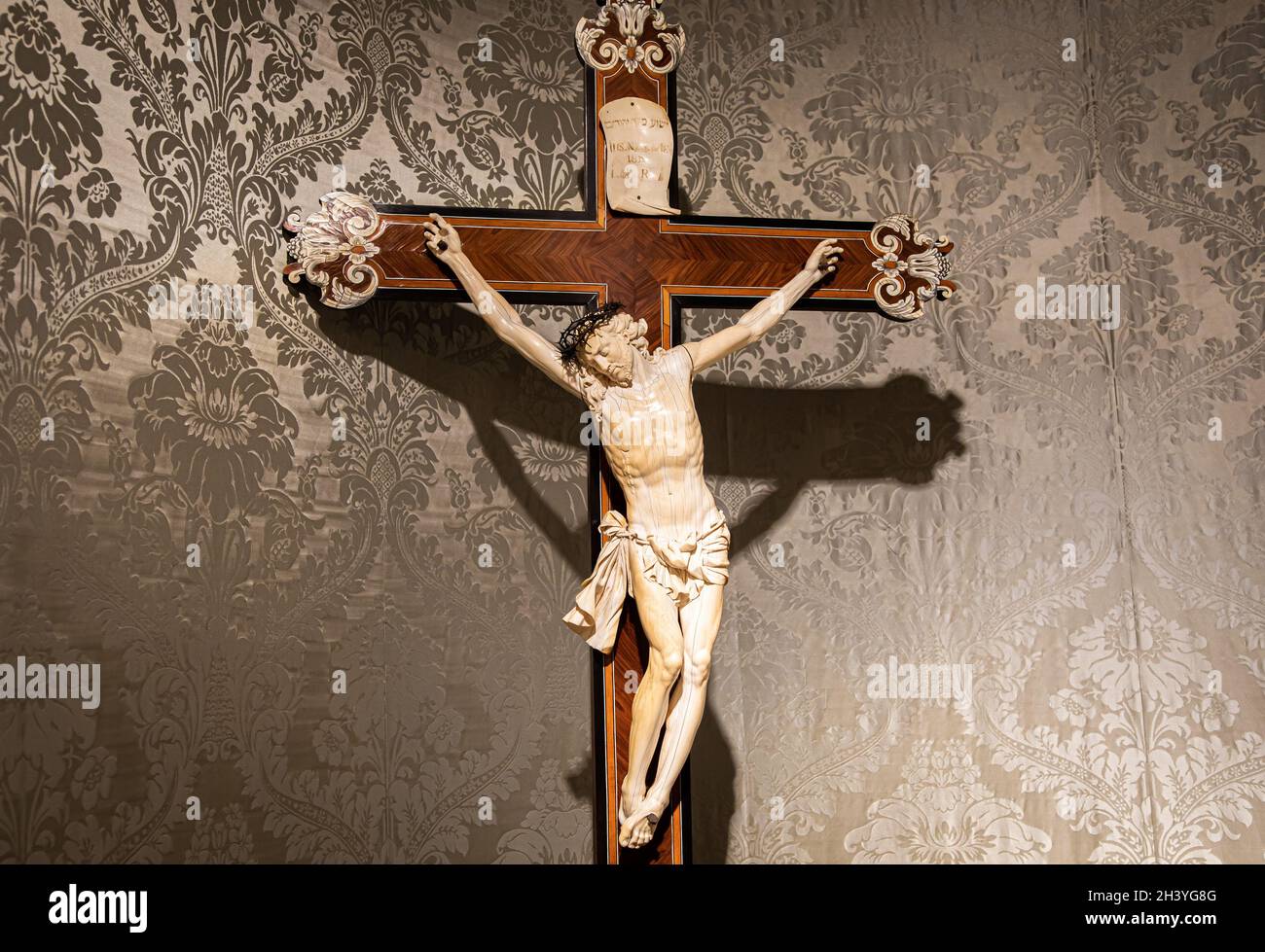 Old crucifix made of wood and ivory. Jesus Christ symbol of resurrection and life after the death. Stock Photo