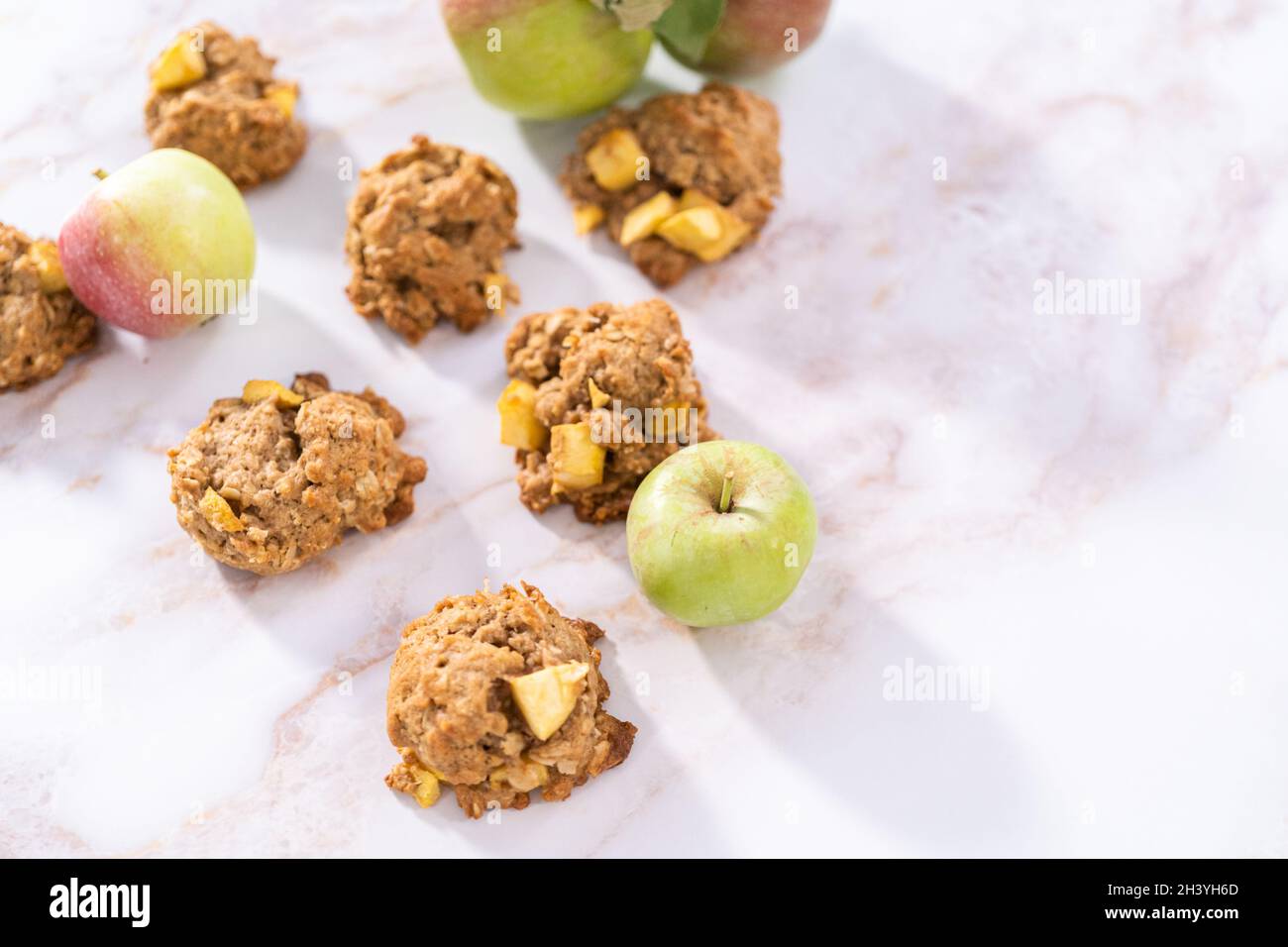 Freshly baked apple oatmeal with apple chunks cookies on a marble ...