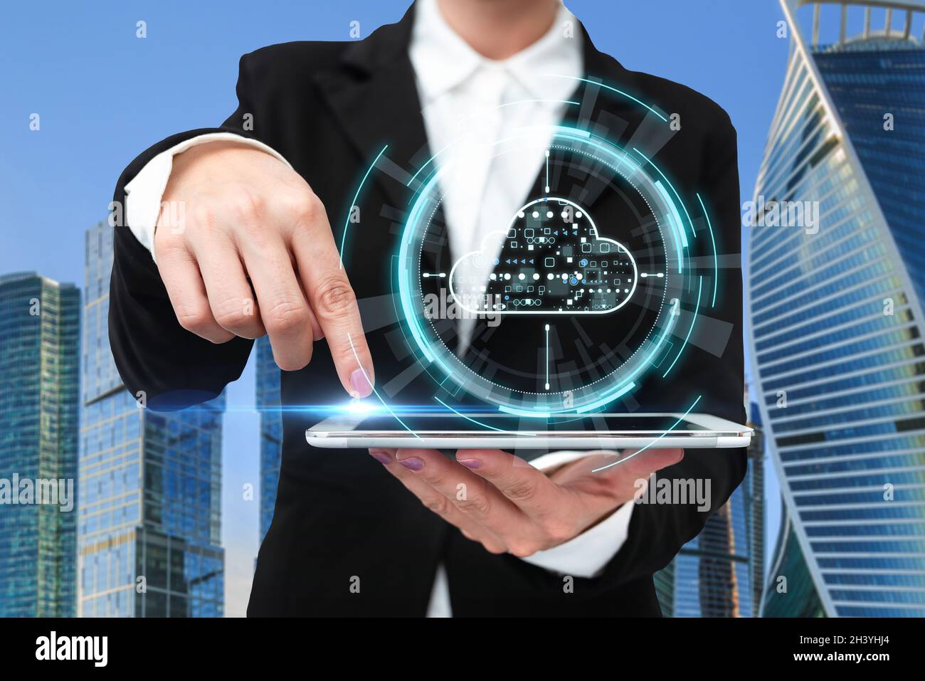 Woman In A Suit Pointing The Top Screen Of Tablet Showing Futuristic Technology. Businesswoman Wearing Uniform Spotting Into Pad Stock Photo