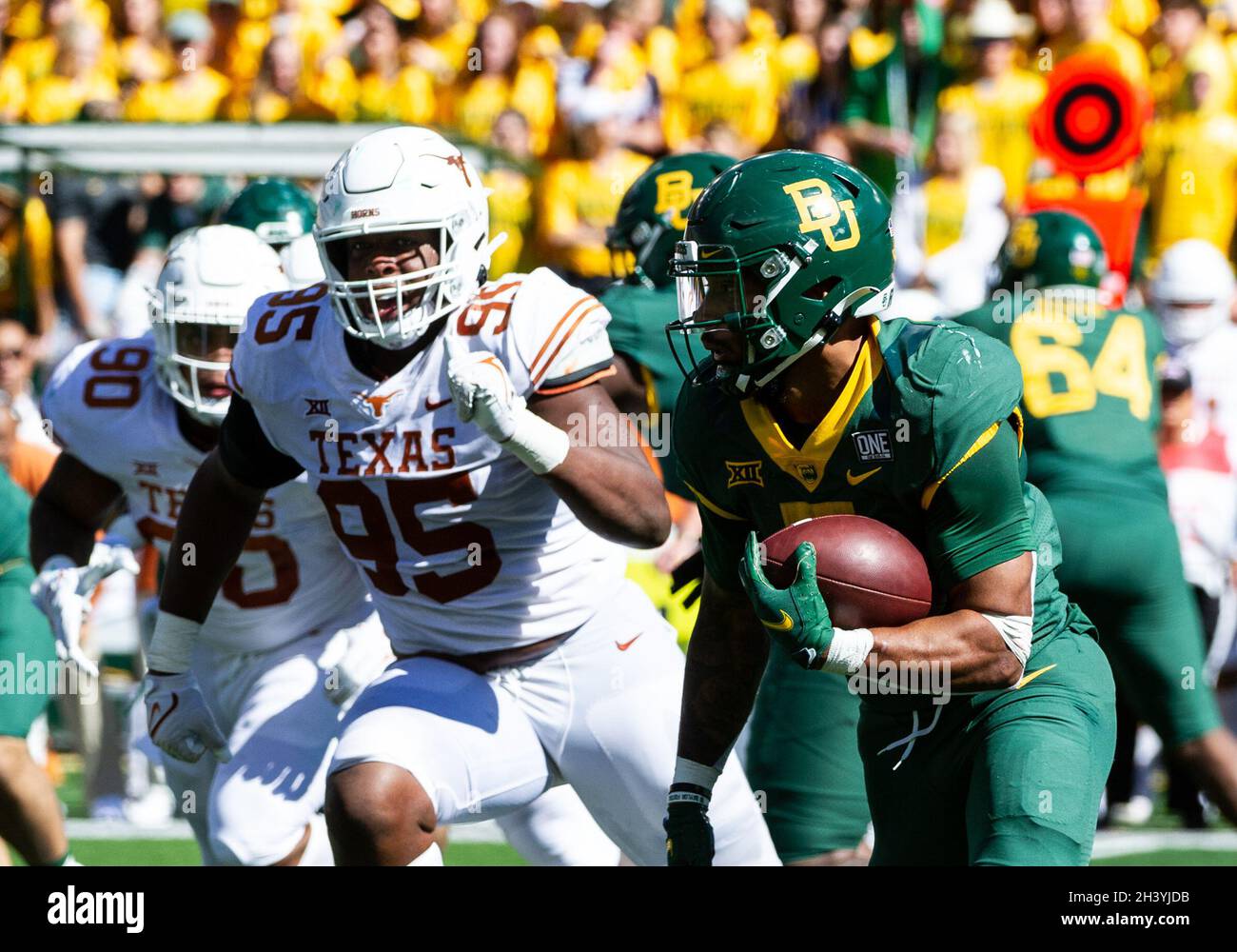 Waco, Texas, USA. 30th Oct, 2021. Texas Longhorns defensive lineman Alfred Collins (95) chases Baylor Bears running back Abram Smith (7) during the 2nd half of the NCAA Football game between the Texas Longhorns and Baylor Bears at McLane Stadium in Waco, Texas. Matthew Lynch/CSM/Alamy Live News Stock Photo