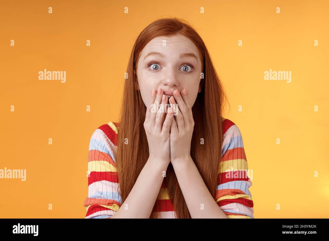 Excited shocked redhead speechless girl like gossiping standing emotional astonished hear amusing story gasping full disbelief c Stock Photo