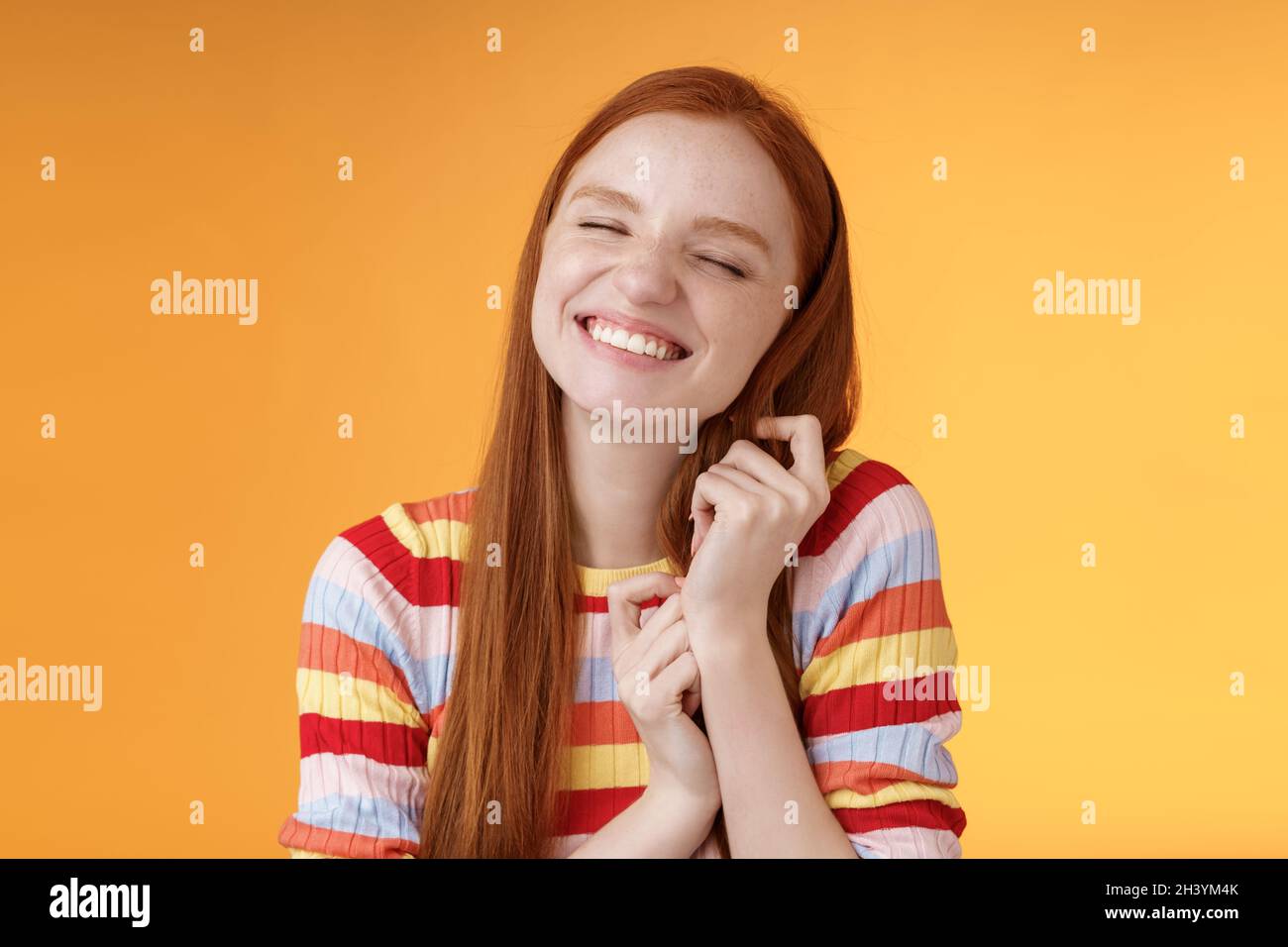 Happy dreamy romantic young tender ginger girl fantasizing creating