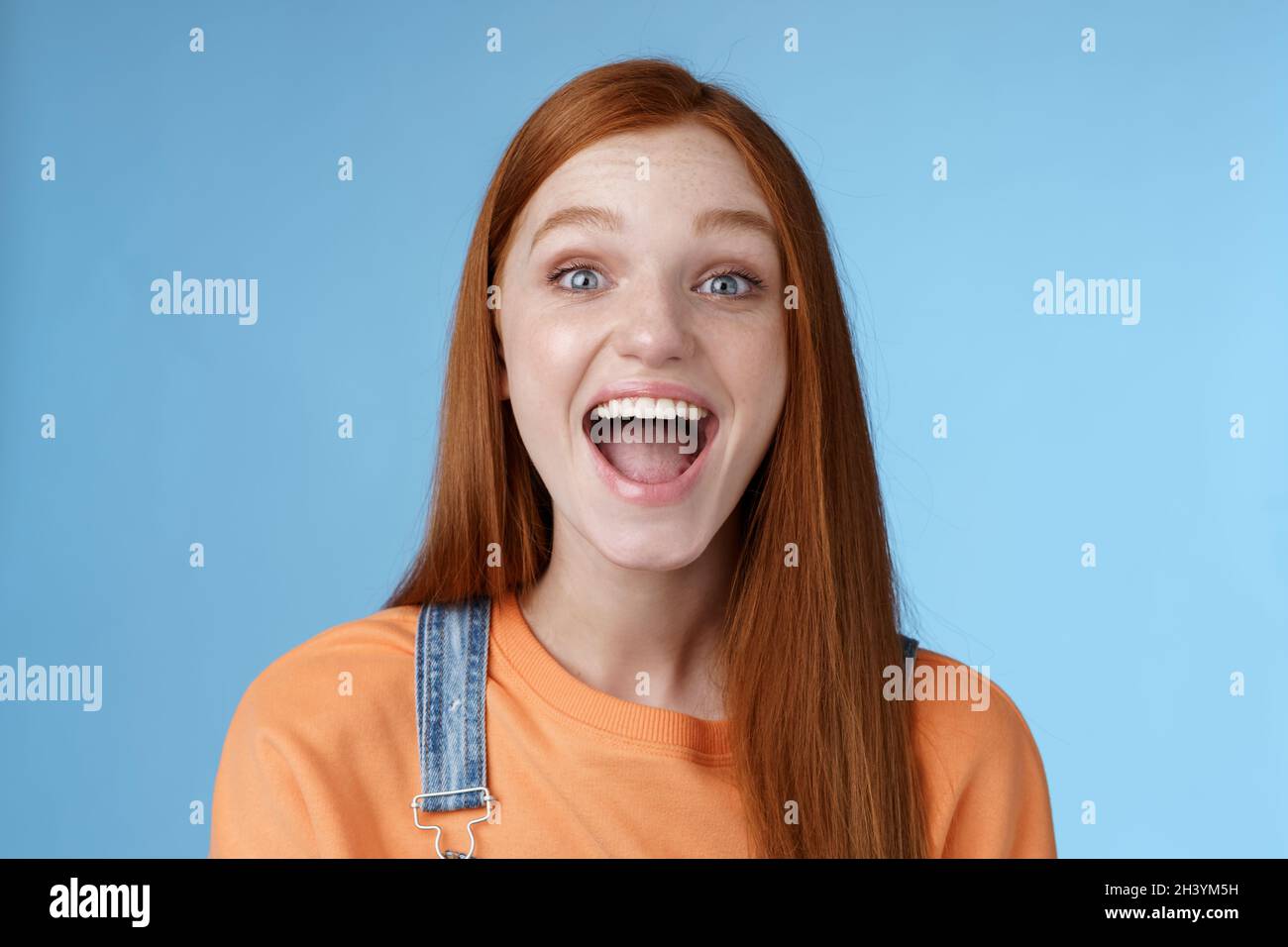Amused charismatic lively outgoing ginger girl thrilled having fun friends yelling say a showing