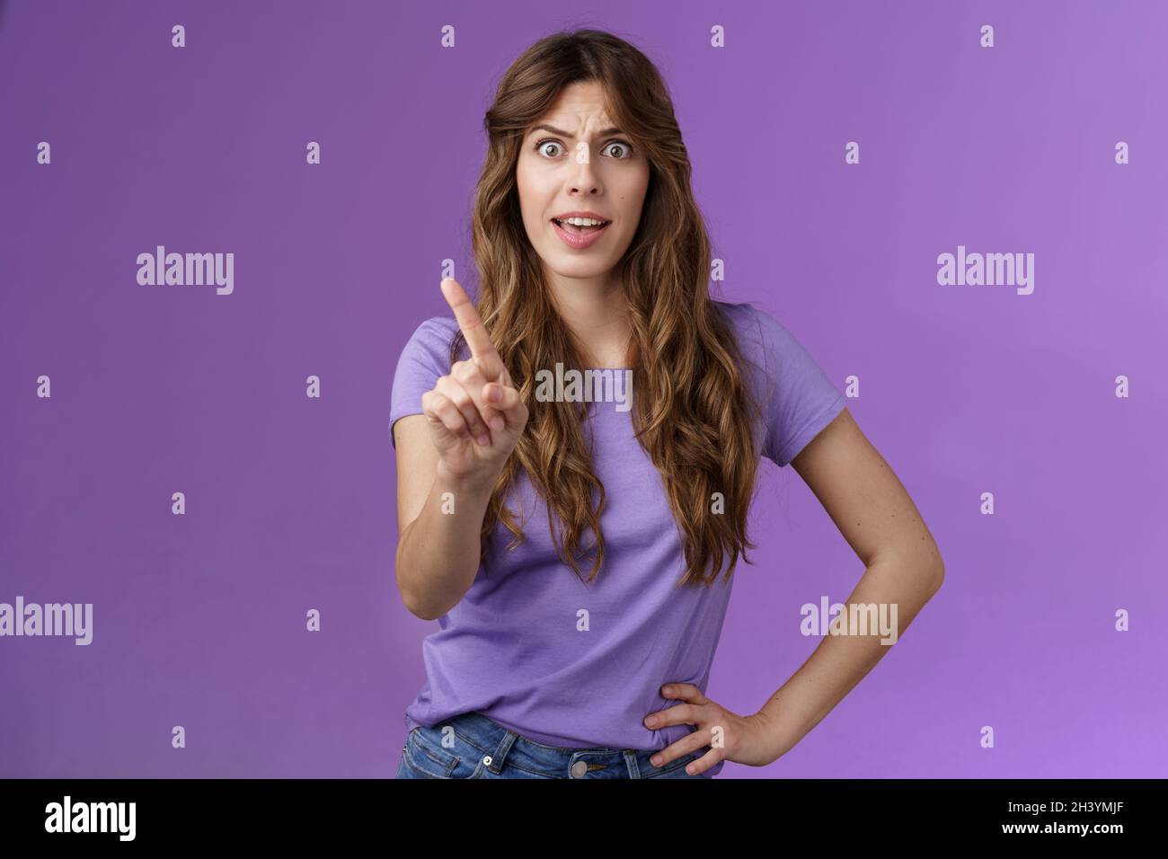 Displeased offended serious-looking assertive woman forbid express dislike and disapproval frowning annoyed shaking index finger Stock Photo