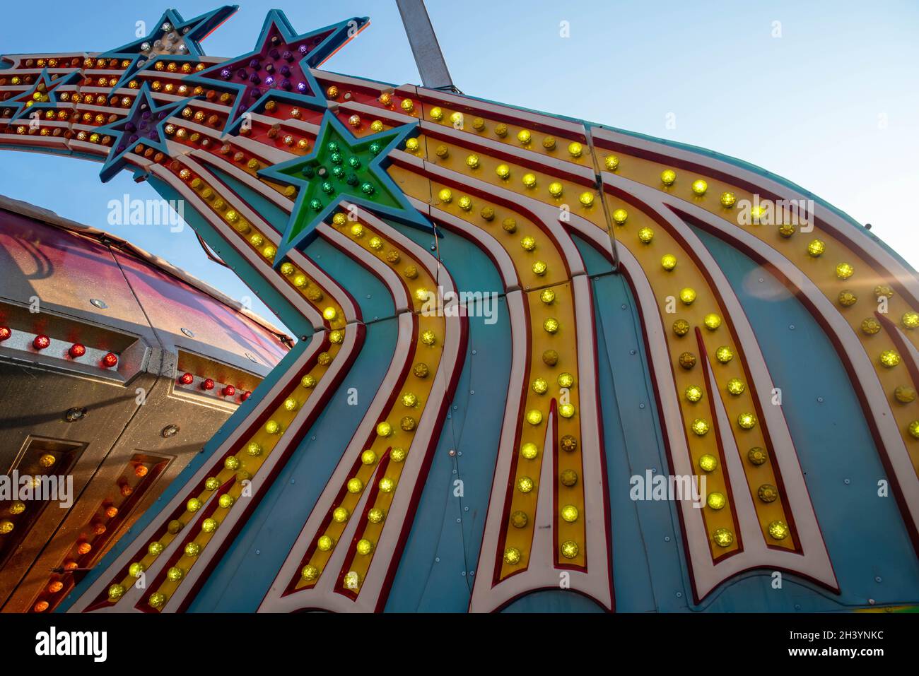 Colorful electric vintage amusement park ride lights with shooting stars Stock Photo