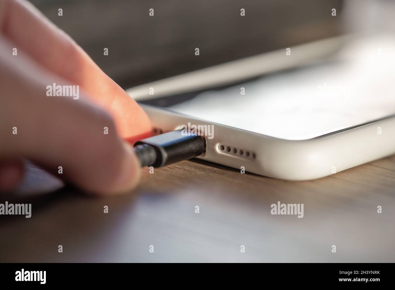 Magnetic cable for charging smartphone, close up. Stock Photo