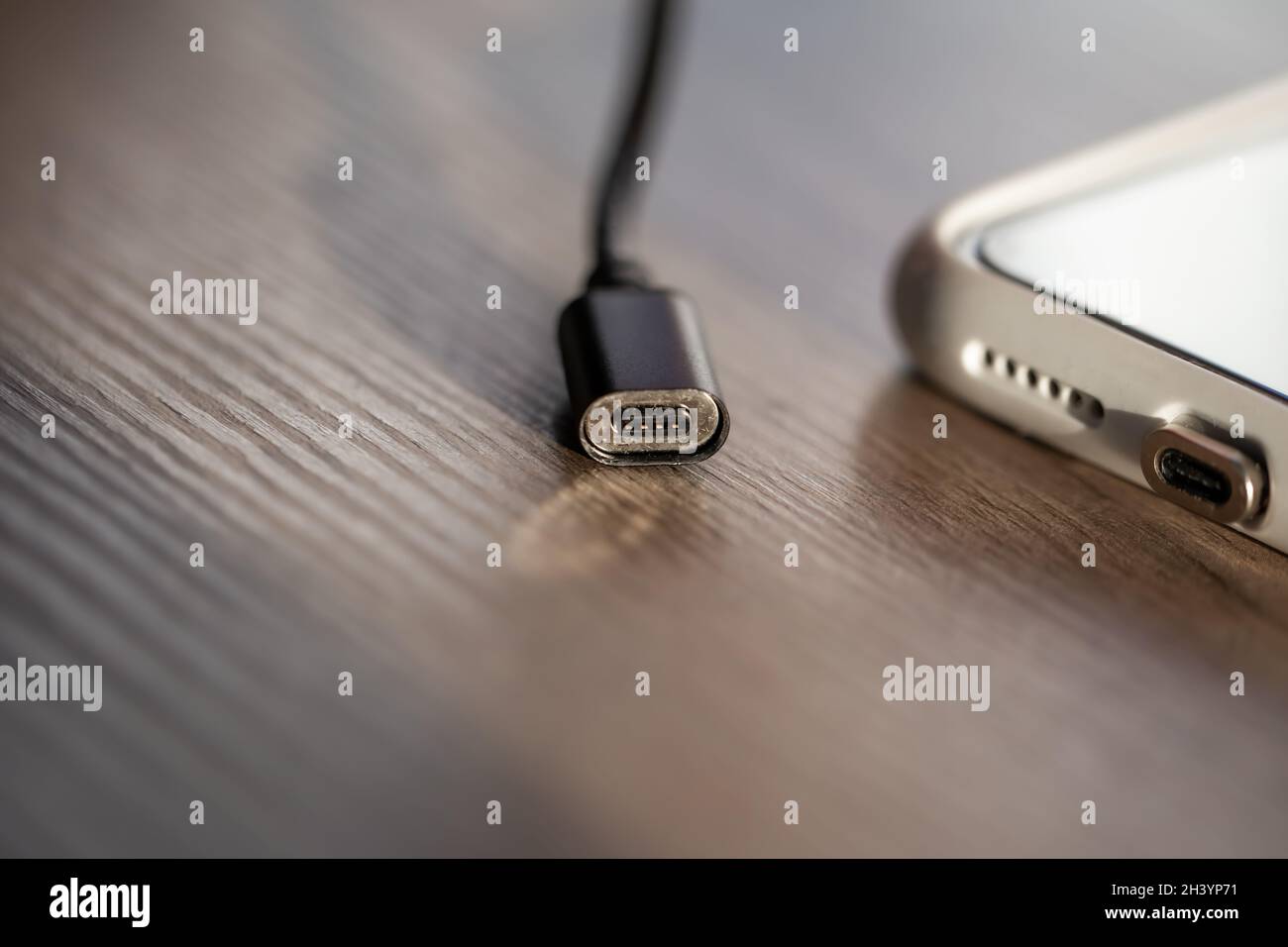 Magnetic cable for charging smartphone, close up. Stock Photo