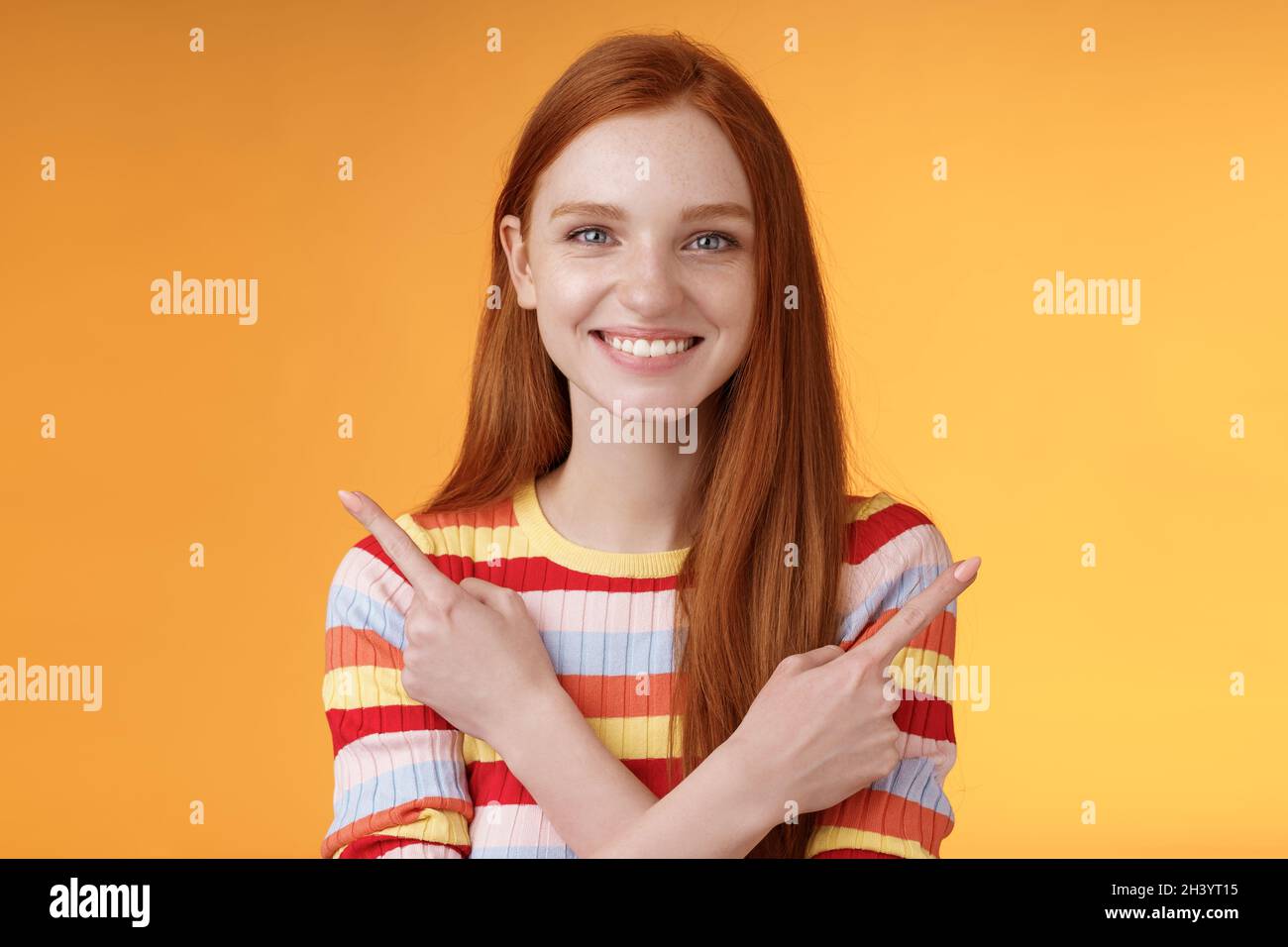 Relaxed carefree confident young helpful redhead girl showing you