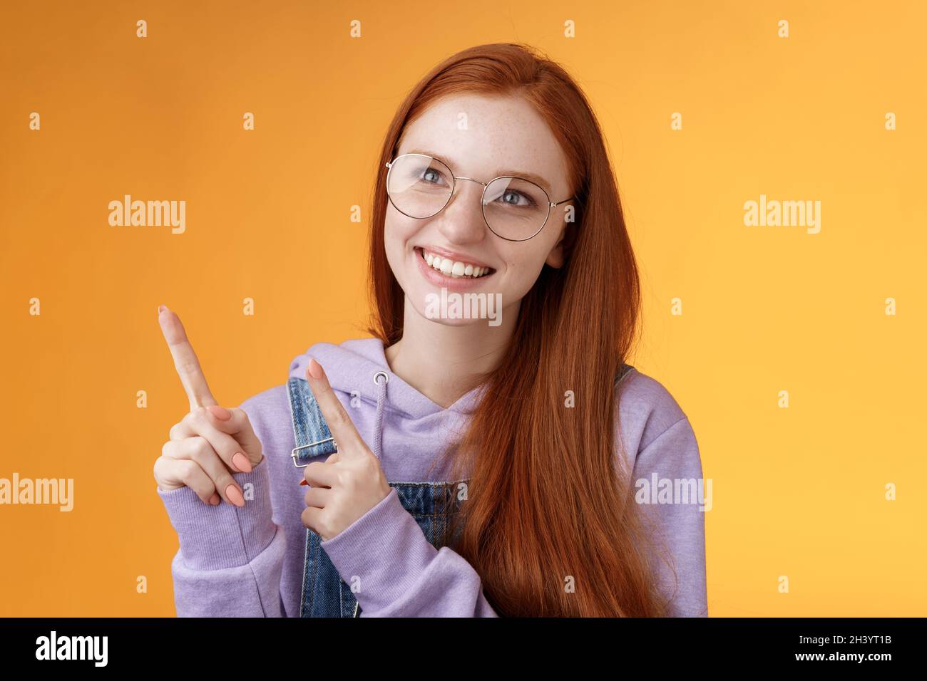 Carefree charismatic happy silly young cute redhead girl freckles blue eyes wearing glasses enjoy contemplating entertaining exh Stock Photo