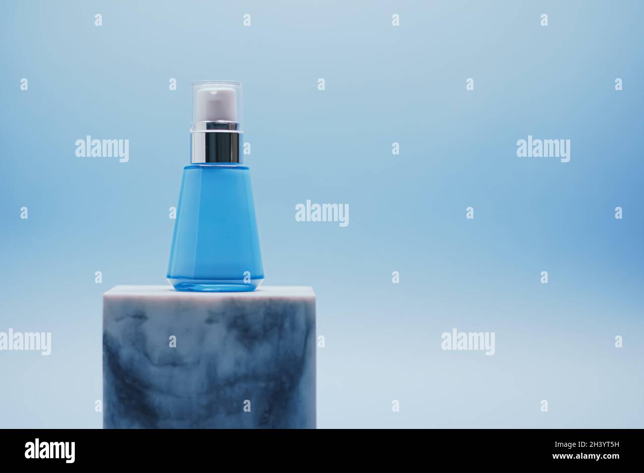 Serum bottle on blue background, luxury skincare products, beauty and