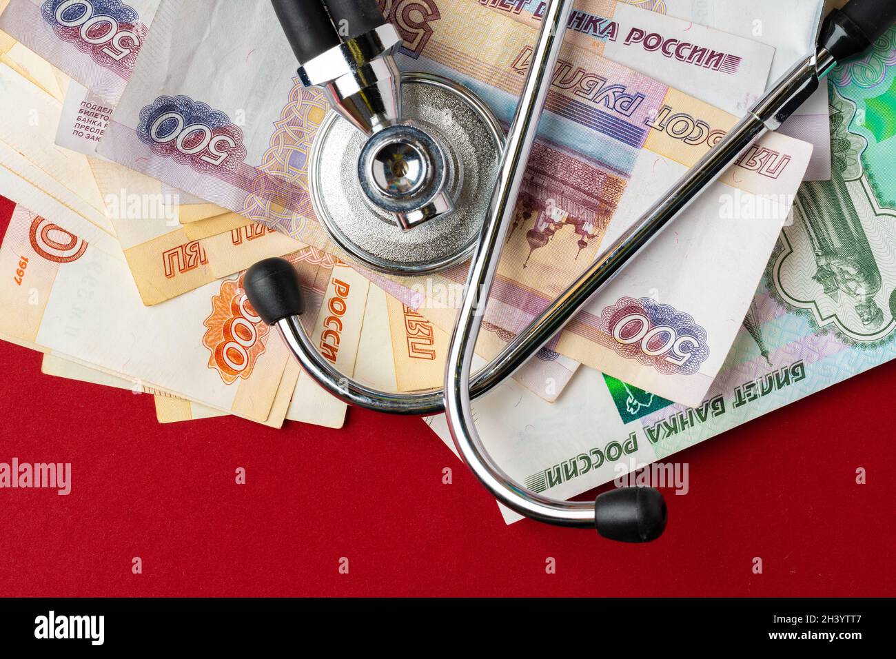 Pile of Russian Rubles with medical stethoscope. Medical expenses
