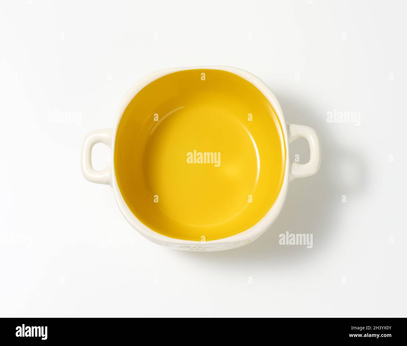 Empty yellow soup plate on white table, top view Stock Photo