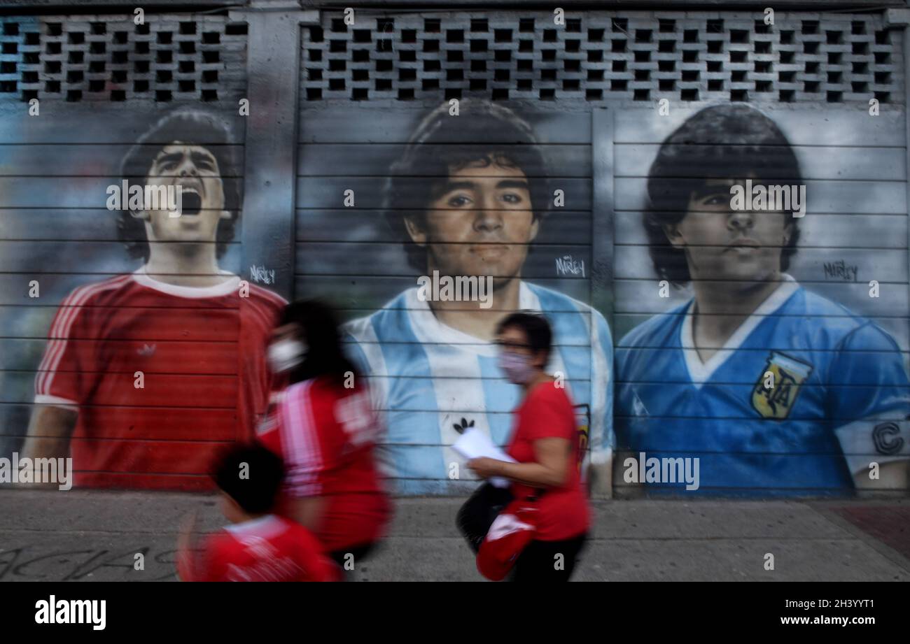 Buenos Aires, Argentina. 30th Oct, 2021. Pictures of Maradona adorn a wall at the 'Diego Armando Maradona' stadium of the Argentinos Juniors Club in the La Paternal neighborhood. The 1986 world champion would have turned 61 on Saturday. Credit: Fernando Gens/dpa/Alamy Live News Stock Photo