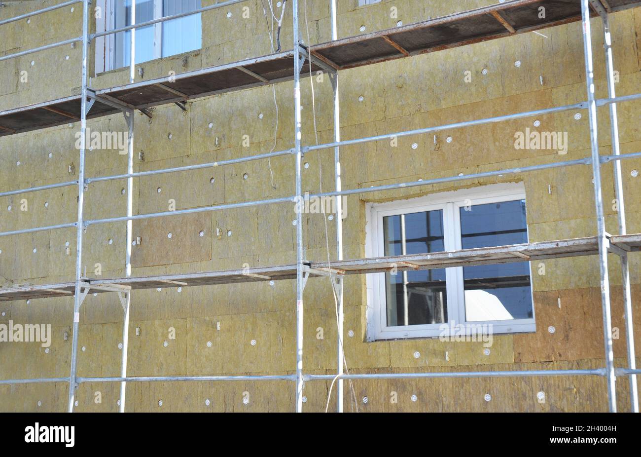 Solid wall insulation with rock wool. Energy efficiency house wall