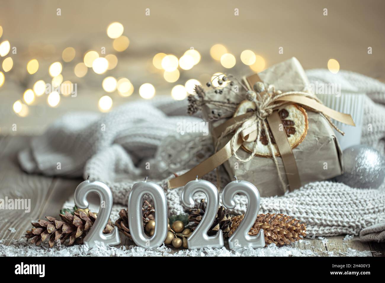 Cozy winter background with burning candles, decorative details