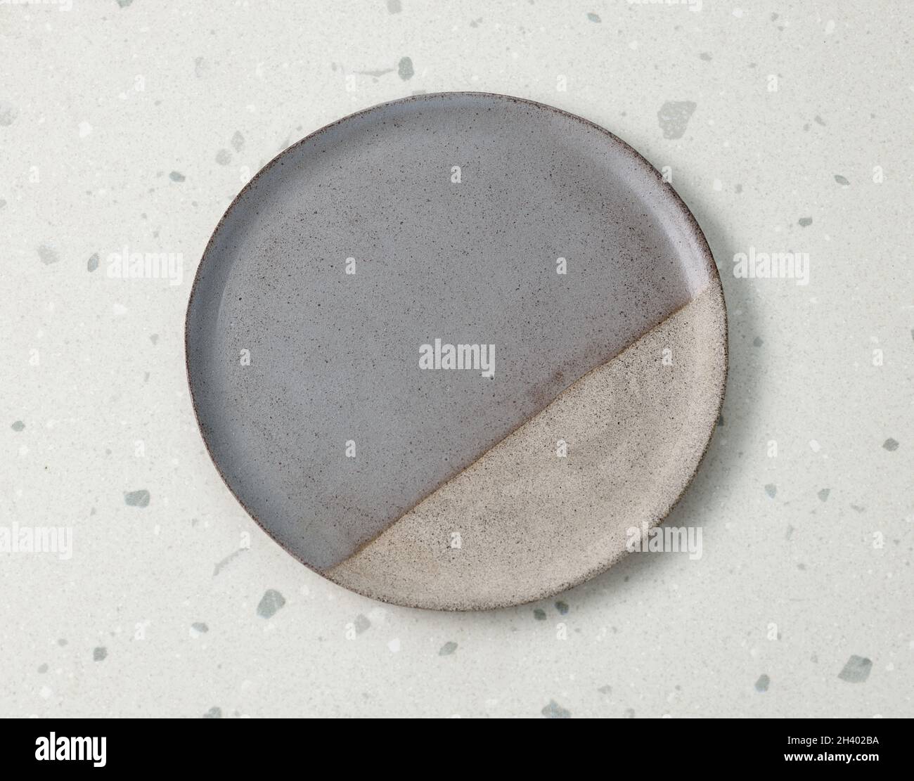 empty ceramic plate on grey kitchen table, top view Stock Photo