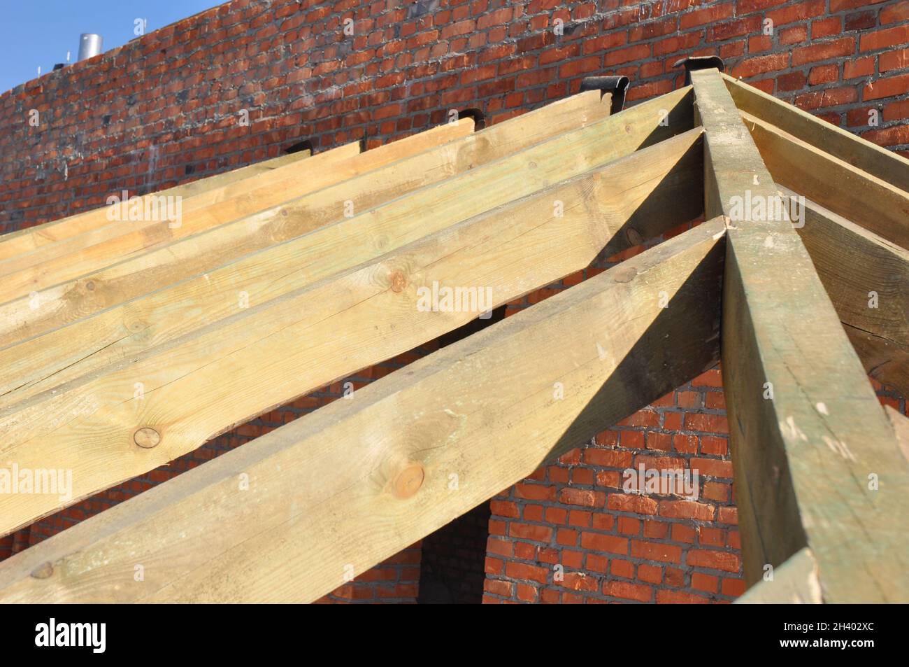 Wooden Roof Frame House Construction with Wooden Beams, Rafters, Trusses, Timber. Stock Photo