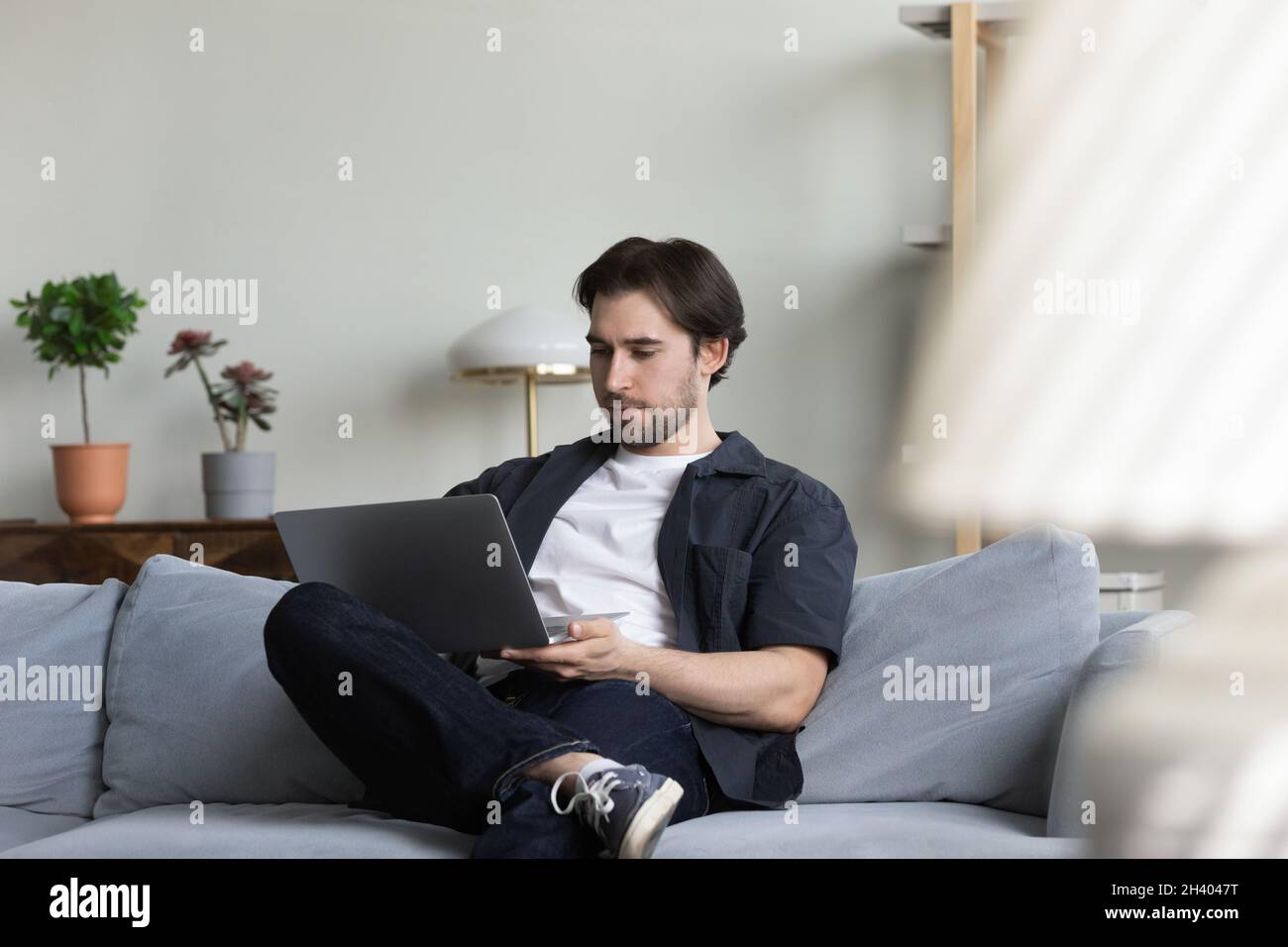 Happy millennial 30s man using computer at home Stock Photo - Alamy