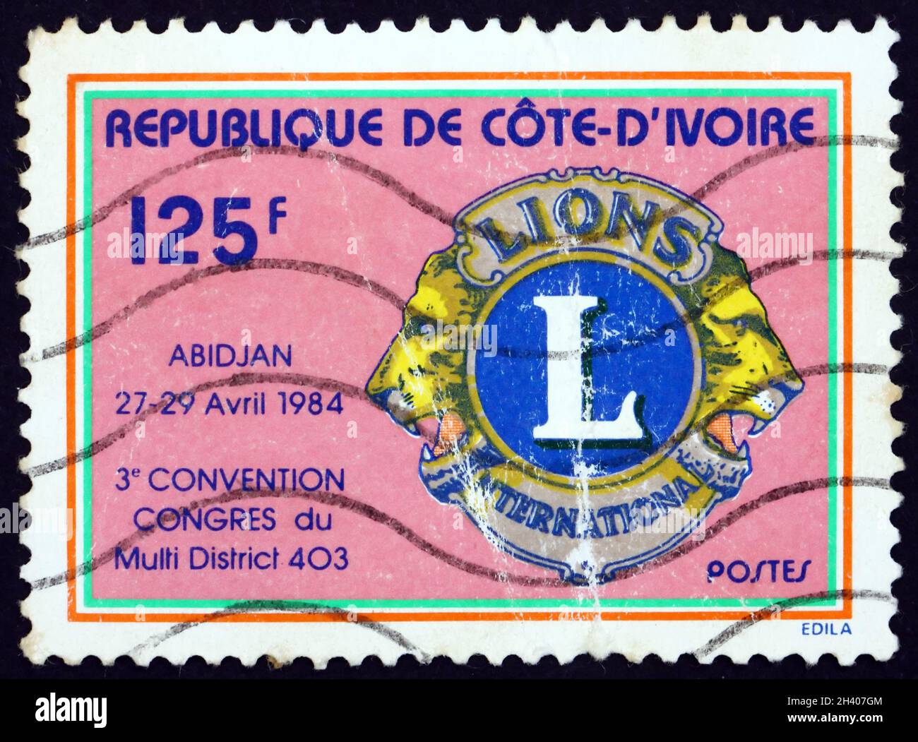IVORY COAST - CIRCA 1984: a stamp printed in Ivory Coast shows Lions Emblem, 3rd Convention of Multi-district 403, Abidjan, circa 1984 Stock Photo