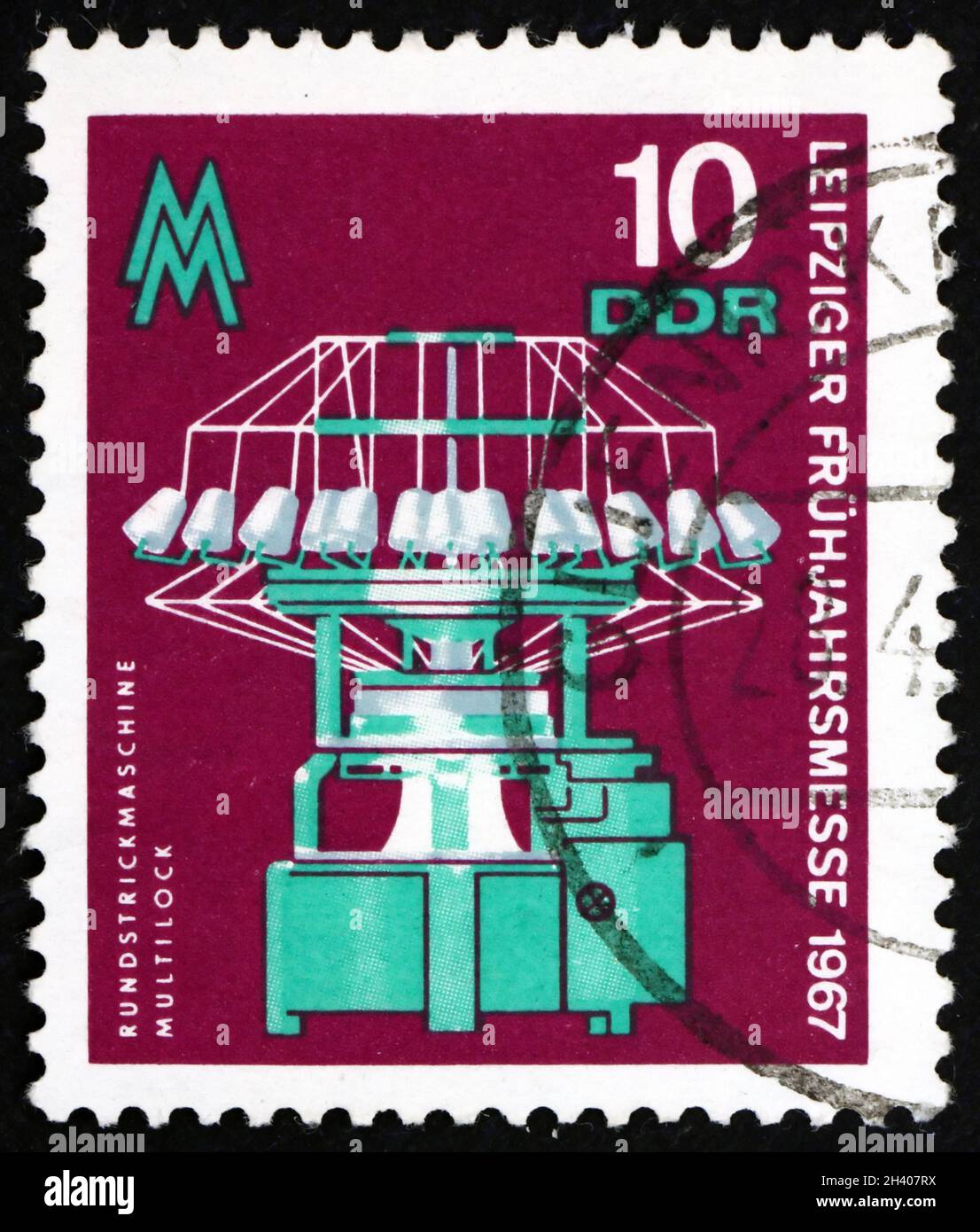 GERMANY - CIRCA 1967: a stamp printed in Germany shows Circular Knitting Machine, Leipzig Spring Fair, circa 1967 Stock Photo