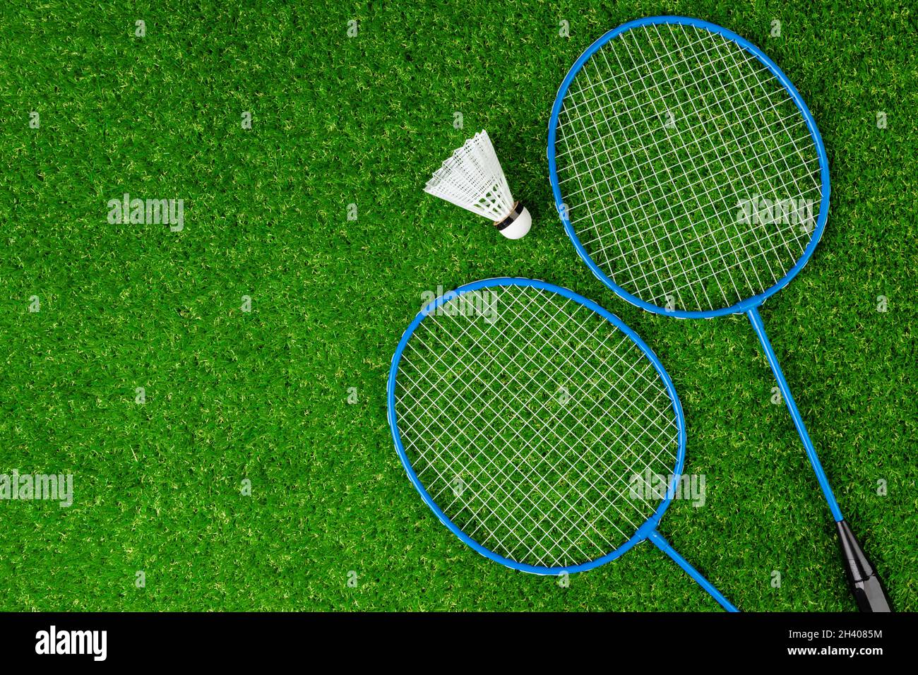 Badminton game rackets and shuttlecock on grass Stock Photo Alamy