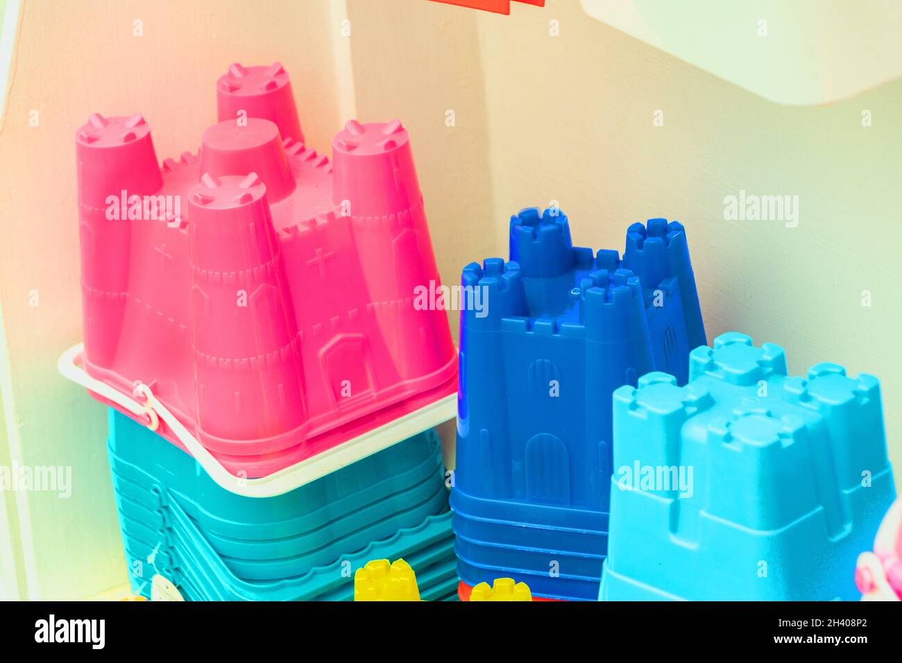 display of brightly coloured plastic buckets and spades and beach toys