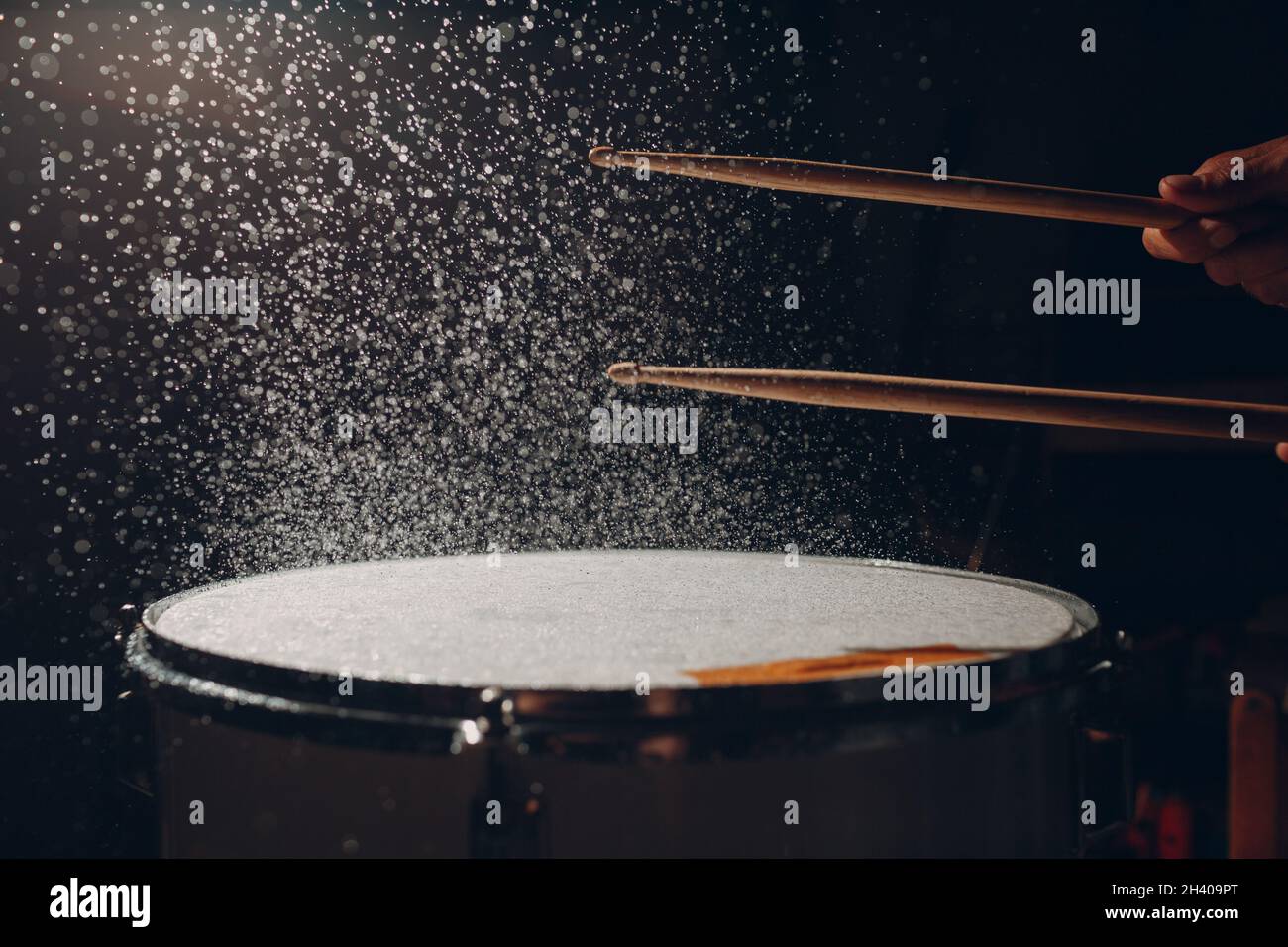 Drum sticks drumming beat rhythm on drum surface with splash water drops Stock Photo Alamy