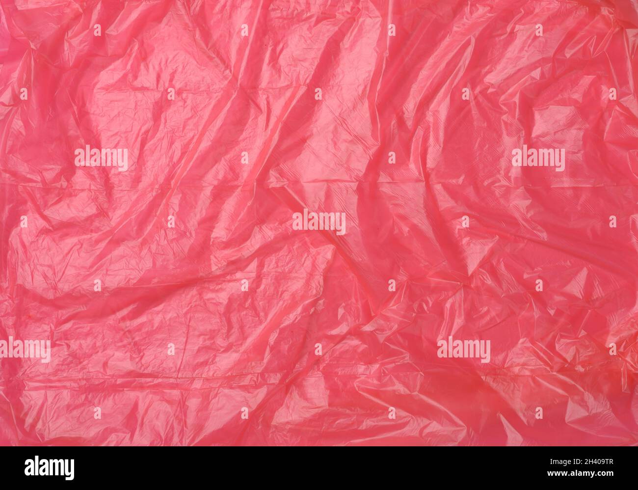 Crumpled red polyethylene texture, close up, full frame Stock Photo