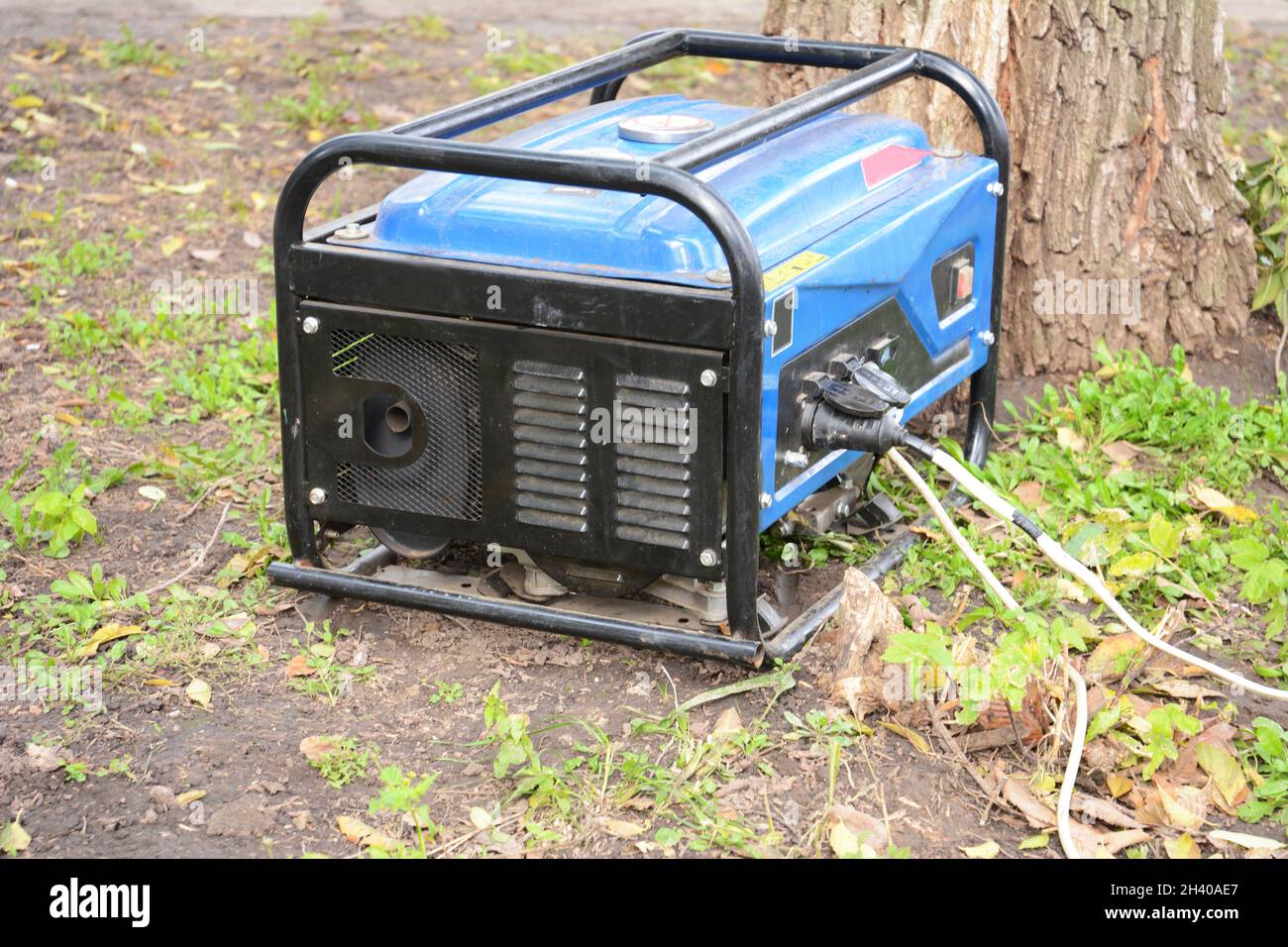 Portable Generator - Outdoor Power Equipment. Mobile backup power generator in the garden. Stock Photo