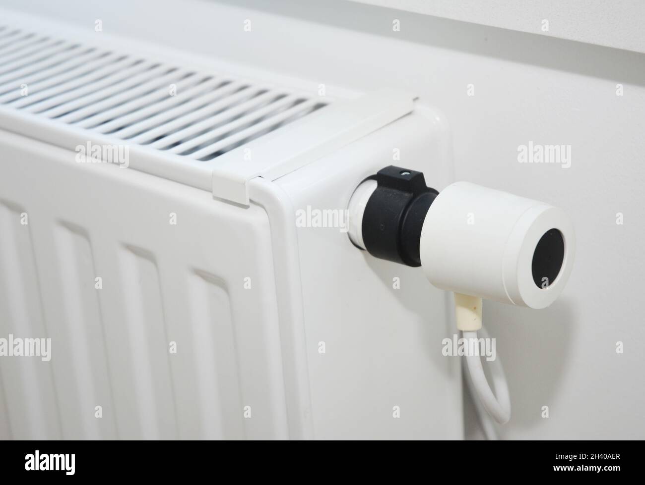 House modern white radiator heating with a thermostat. Stock Photo