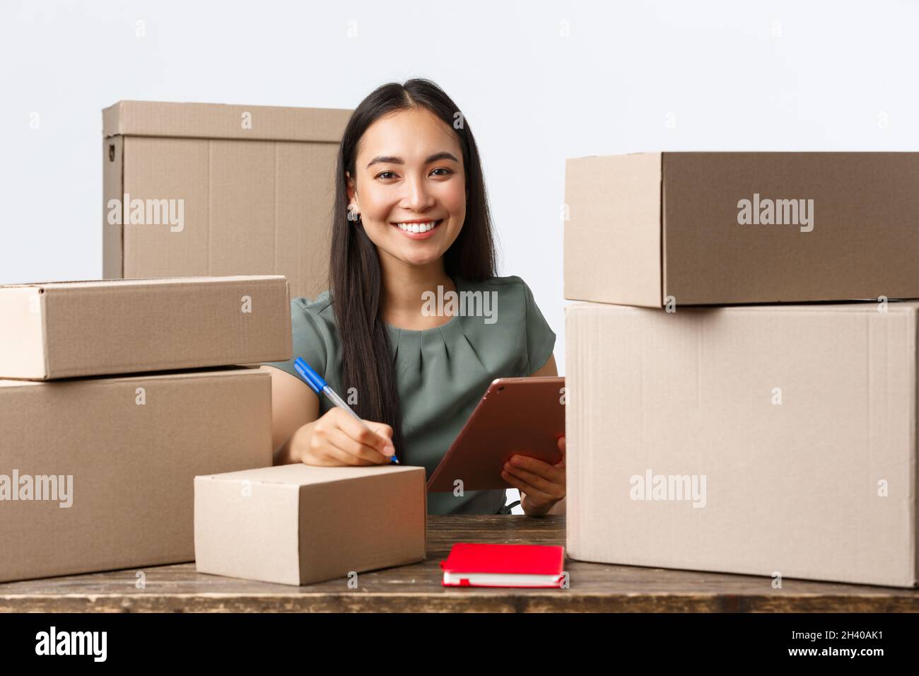 Small business owners, startup and e-commerce concept. Smiling successful asian businesswoman with own internet shop, selling on Stock Photo