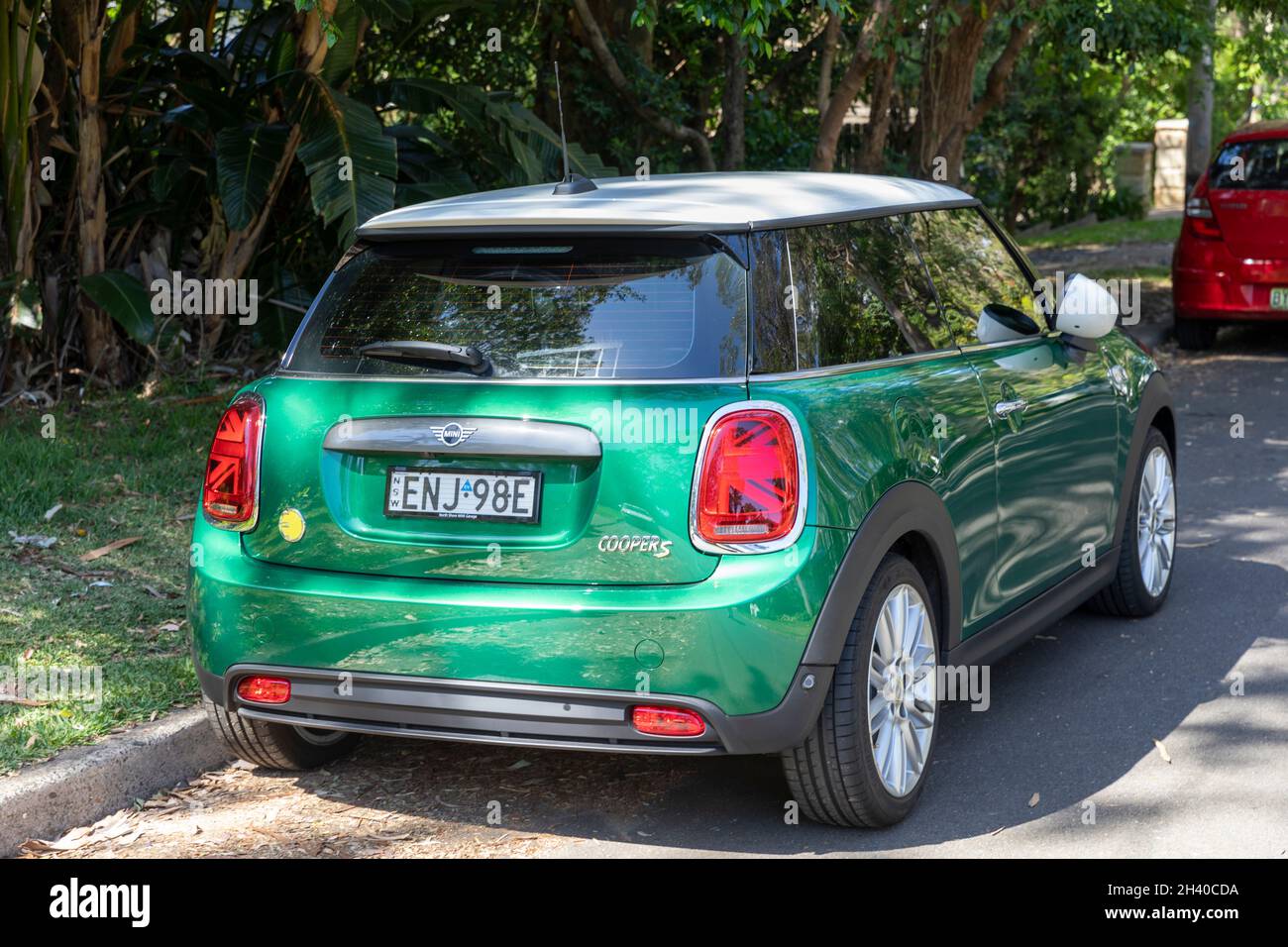 Electric powered 2021 Mini Cooper S in green body with white roof on a Sydney street,NSW,Australia Stock Photo