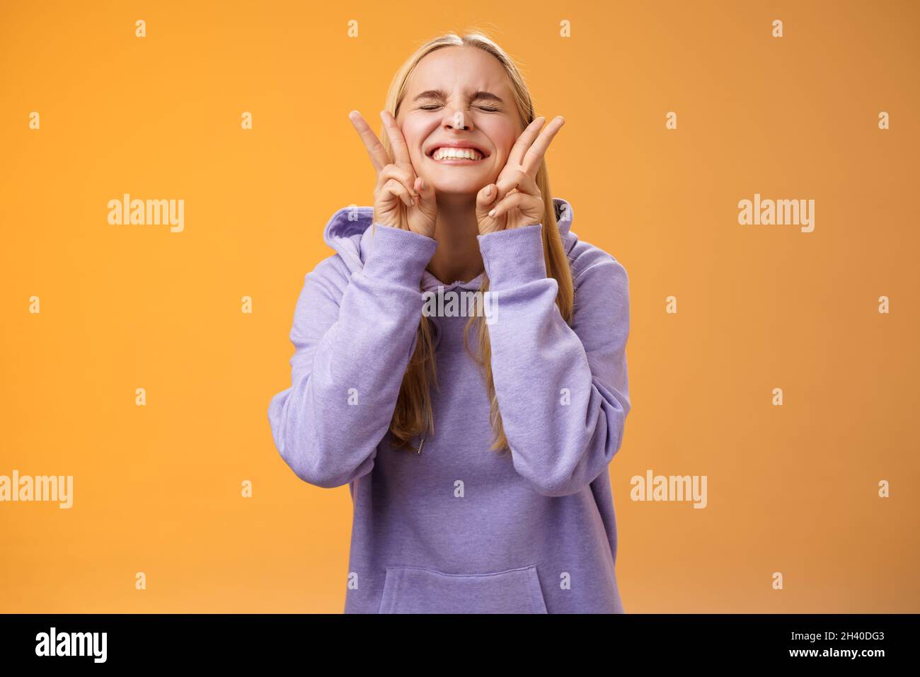 Excited lucky charming friendly blond girlfriend having fun celebrating perfect news best score receive scholarship smiling amus Stock Photo