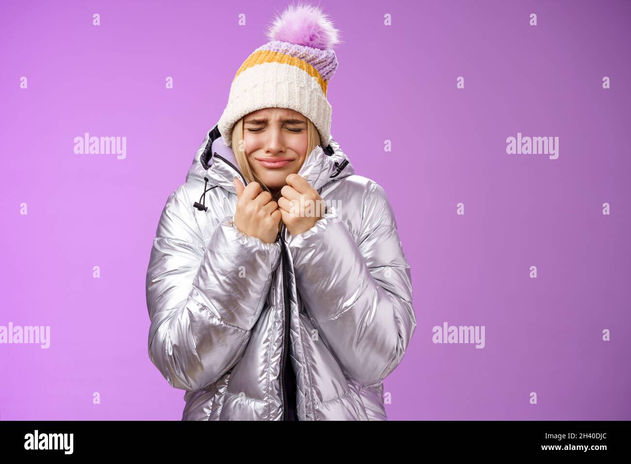 Unhappy sobbing whining cute blond girl pull jacket tight body close eyes crying freezing cold standing snowy winter resort shak Stock Photo